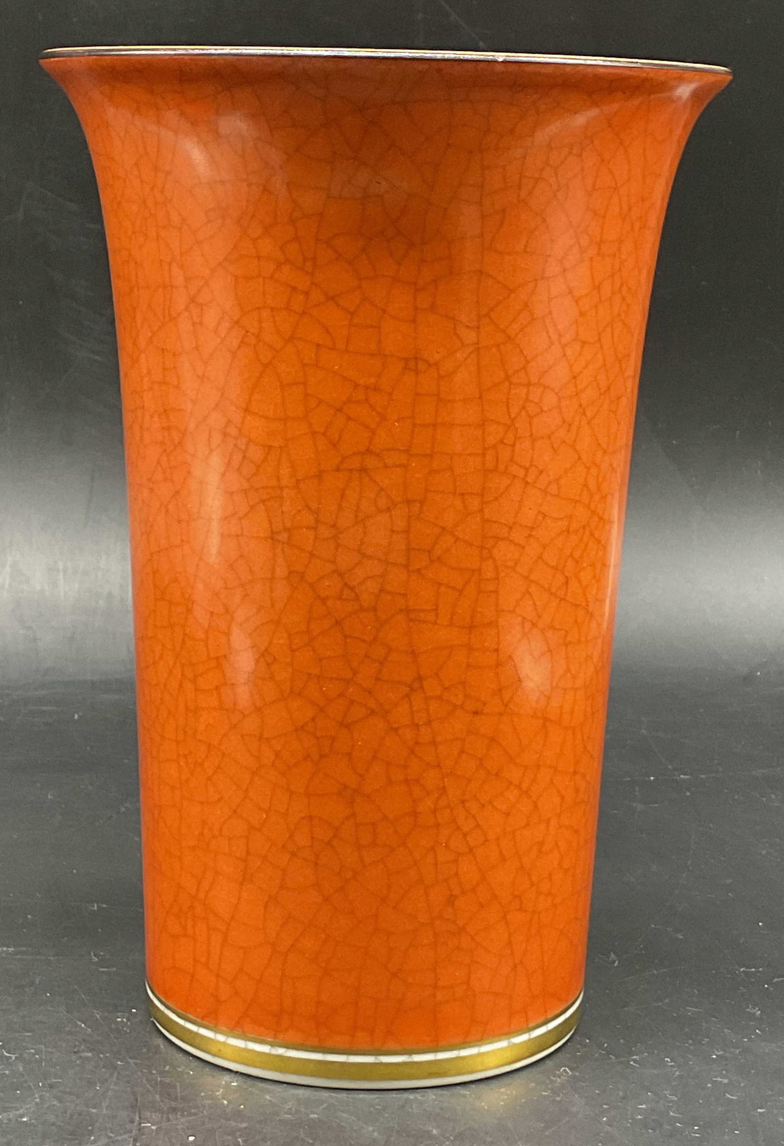 Royal Copenhagen Craquelure Trumpet Vase Denmark: Thorkild Olsen for Royal Copenhagen craquelure porcelain trumpet vase. Marked on underside, made in Denmark. Striking orange crackle glaze. Gilt rim and base. Measures ht approx 7.5 inches diam approx