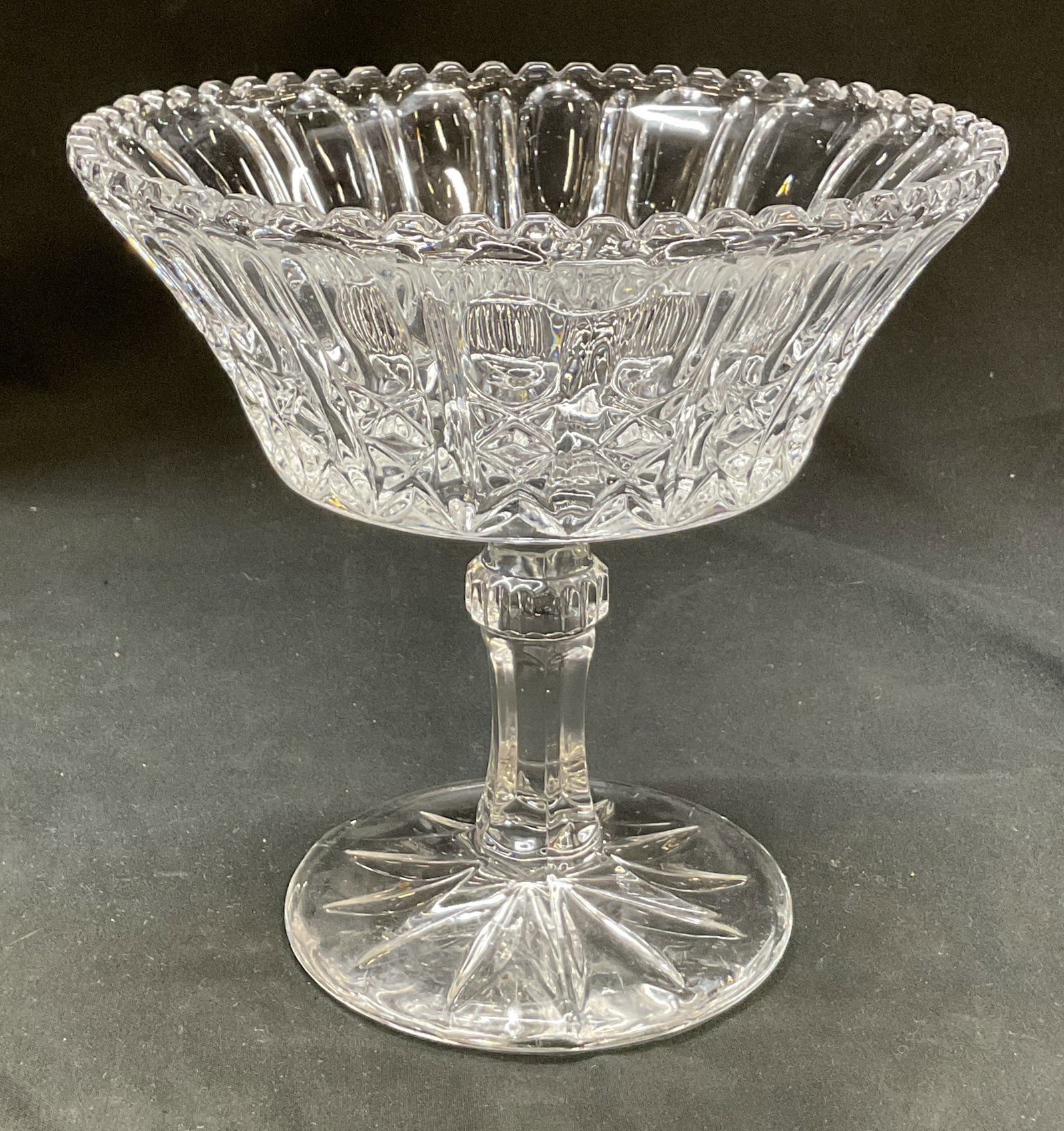 Vintage Cut Crystal Pedestal Compote: Vintage cut crystal pedestal compote. Round base with faceted stem. Sawtooth rim. Cut geometric patterns. Measures ht approx 6.5 inches diam approx 7 inches. Scratching. Compote, tableware, home decor