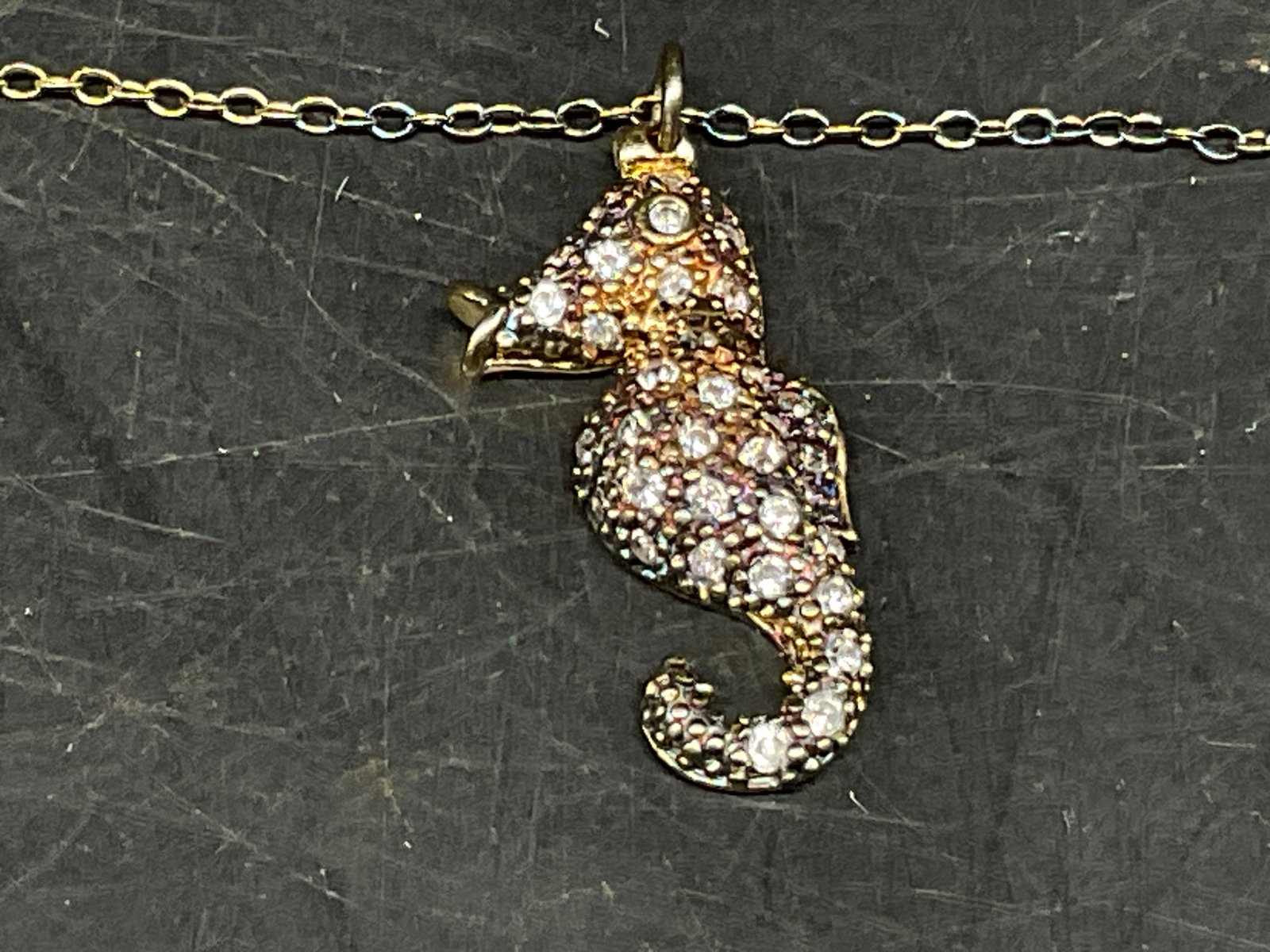 Devi Rao STERLING Ombre Seahorse Necklace OB: Devi Rao Sterling Silver Seahorse Necklace. Gold-Plated with Blue, Pink, and Purple Ombre Effect. Micro-Pave Clear Crystal Embellishments. Comes in Original Branded Box. Some Tears on Box. Removed to 