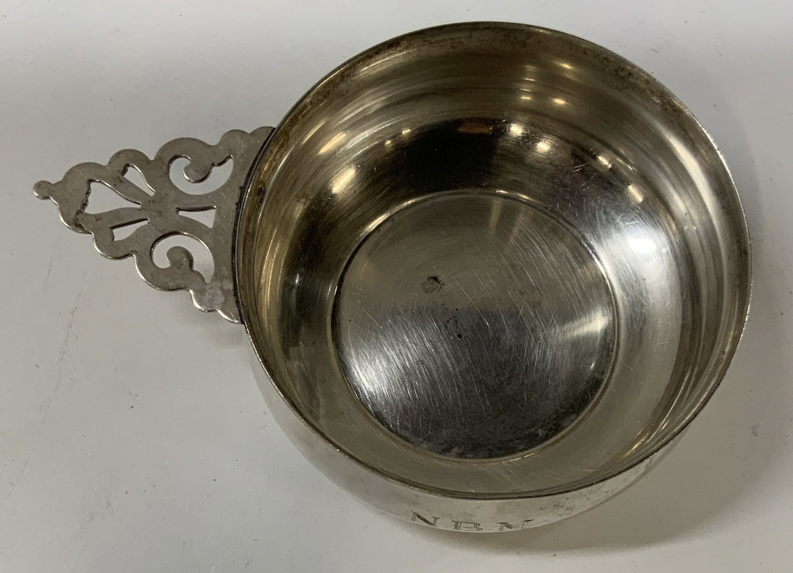 Vntg silver plated Porringer: . Porringer is a shallow bowl. Piece features a distinct ornate pierced and scrolled handle. side is stamped with personal engraving N.B.M. 10-22-01. Typically given as a baby gift most likely initial