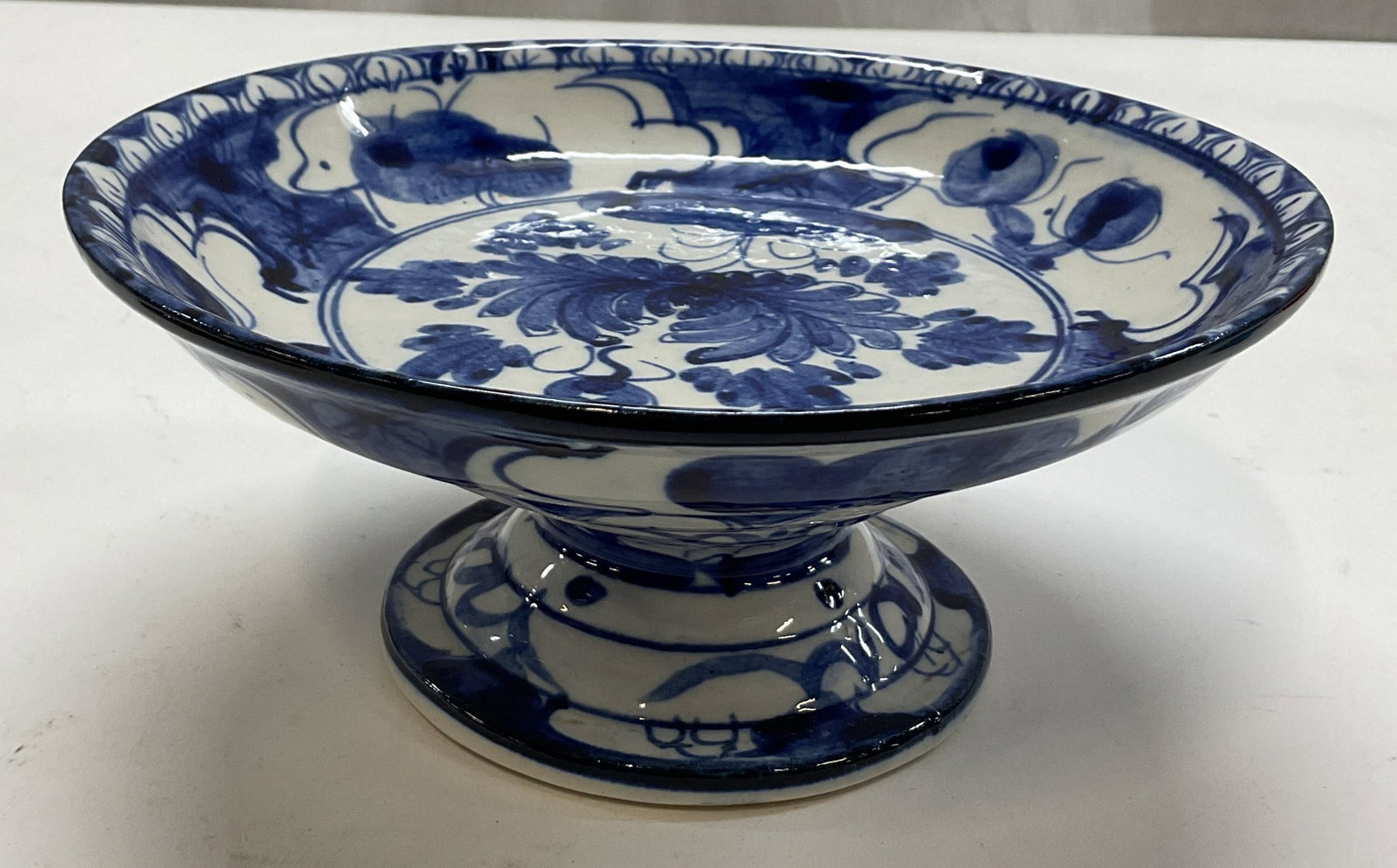 Vtg Chinese Porcelain Blue & White Pedestal Tazza: Vintage Chinese porcelain blue and white pedestal tazza. Round pedestal base. Shallow wide bowl on top. Hand painted floral and scroll motifs in blue. Measures ht approx 3.5 inches diam approx 8 inche