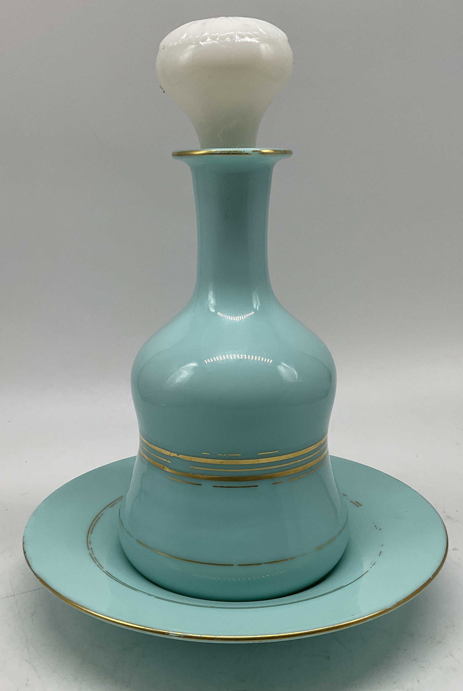 19thC French Opaline Glass Decanter & Underplate: Antique 19th Century French Turquoise Opaline Glass Decanter and Underplate. Night Service Pattern. White Glass Stopper. Gilt Trim. Losses to Trim Present. Measures app 10.5in H x 7.75in Diam on Under