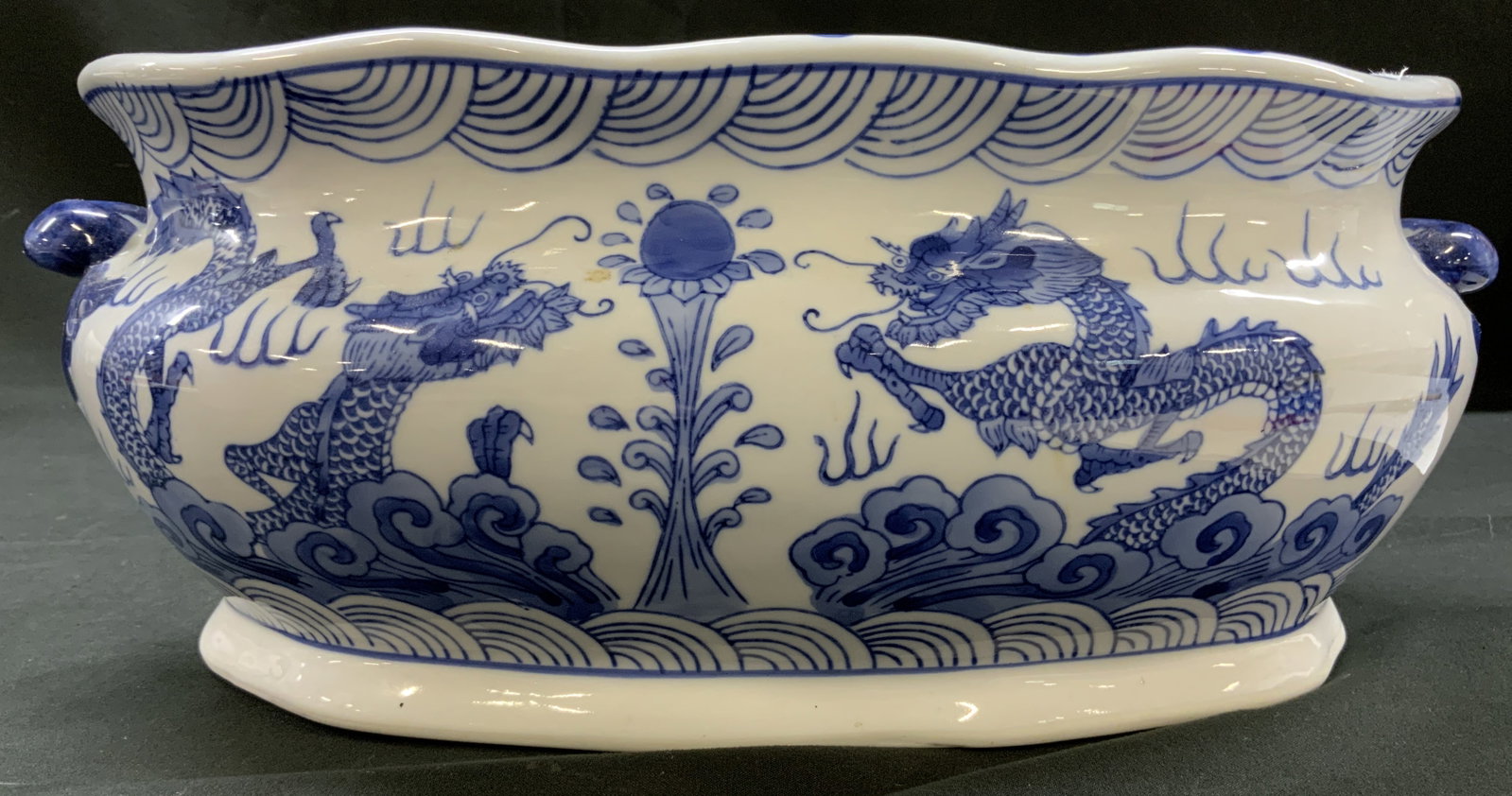 Vtg Blue&White Dragon Decorative Cache Pot: Vintage Chinese glazed ceramic decorative cachepot, elongated footed planter basin. Exterior body features traditional cobalt blue Transfer-printed illustrations of imperial dragons, flaming pearls, s