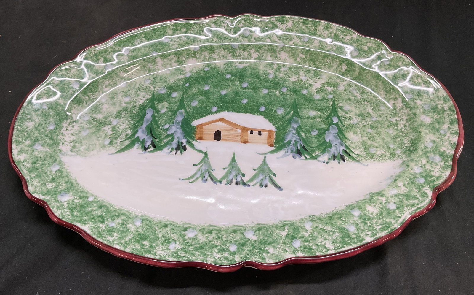 R.H. Macy & Co Cellars Log Cabin Serv Pltr Italy: R.H. Macy & Co The Cellars Log Cabin Christmas collection ceramic serving platter. Marked on underside, reads R.H. Macy & Co Inc Made In Italy Expressly For Macys. Scalloped red edge. Hand painted sno