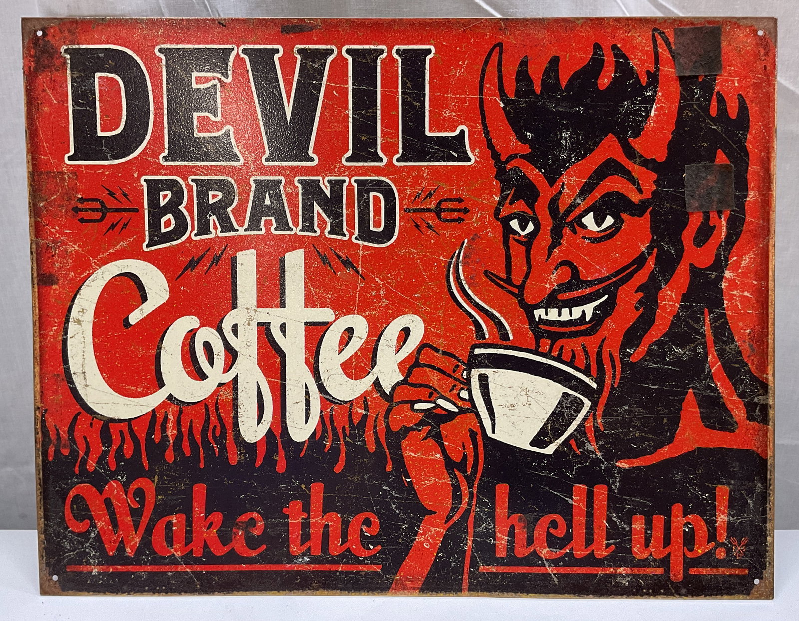 2014 Desperate Enterprises Devil Coffee Sign USA: Desperate Enterprises Devil Brand Coffee tin wall sign. Made in USA. 2014 copyright Factory Supply Co. Manufactured and distributed by Desperate Enterprises. Red black and white humorous illustration 