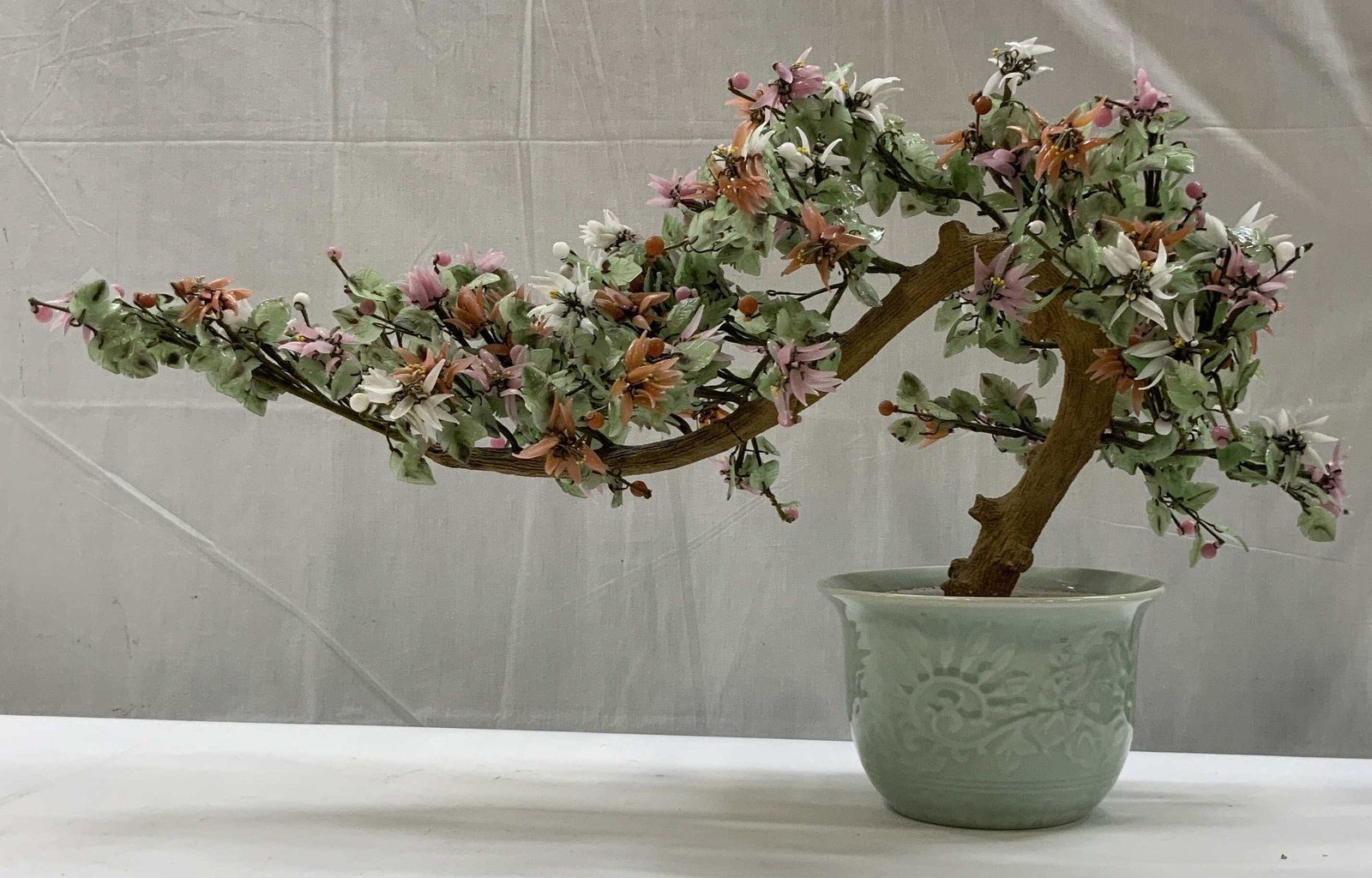 Vntg Chinese decorative bonsai tree: Vintage Chinese decorative bonsai tree. Mid 20th century style. Features delicate Patel hued gemstone blossoms arranges in a sweeping faux wood trunk set in a celadon pot. Measures app 17 in height , 