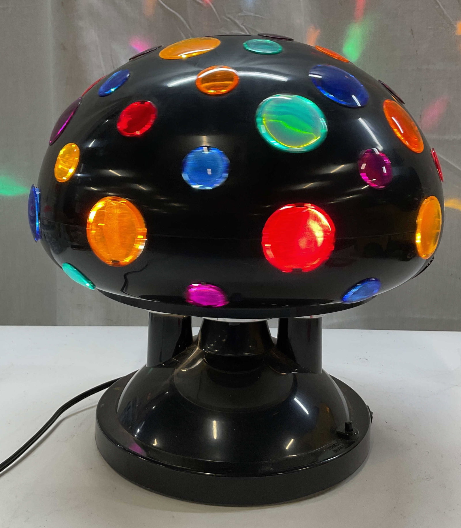 Vtg Rabbit Tanaka Rotating UFO Disco Lamp: Vintage Rabbit Tanaka rotating UFO disco lamp/mushroom lamp. Marked on underside as photographed here. Black rotating dome inset with colorful plastic jeweled lens caps. Internal bulb rotates to cast 