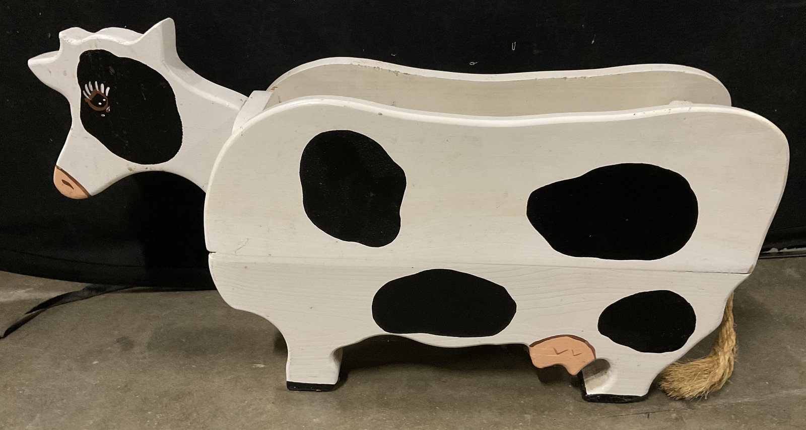 Handmade Wooden Cow Planter Box: Handmade Wooden Cow Planter Box. Painted Black and White Holstein Pattern. Cutout Head. Rope Tail. Condition Consistent With Exposure. Measures app 12.5in H x 24.5in L x 6in Diam. Handmade, Woodcraft,