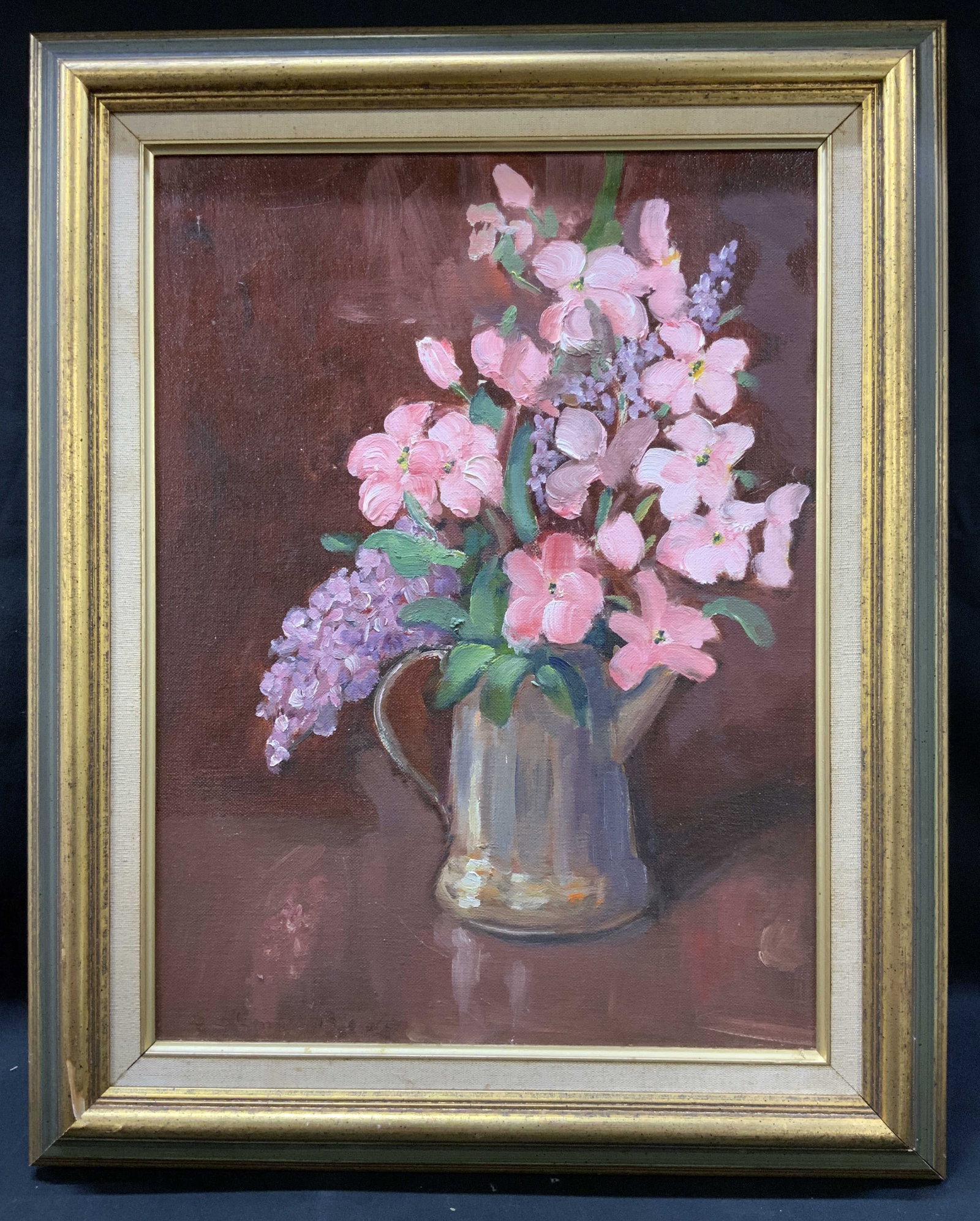 Vtg Framed Floral Still Life Oil Painting: Vintage framed floral still life oil painting on canvas board. Pink and purple florals arranged in silver toned metal pitcher/jug against burgundy background. Framed in ornate gold gilt wood frame wit