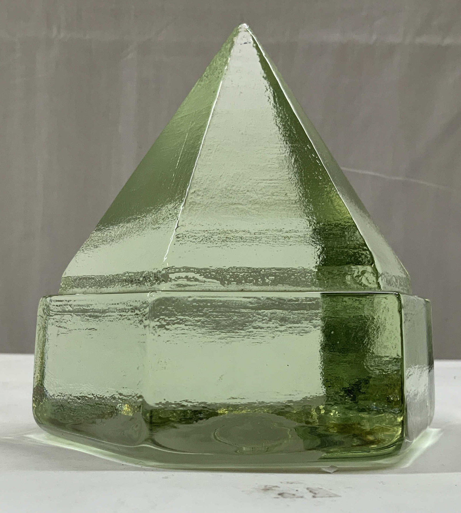 Light green glass ship deck prism/paperweight: Light green glass ship deck prism/paperweight. A ship deck prism is used to refract natural sunlight below deck without created a flame or fire hazard. Featuring a hexagon base rising to a pyramid top