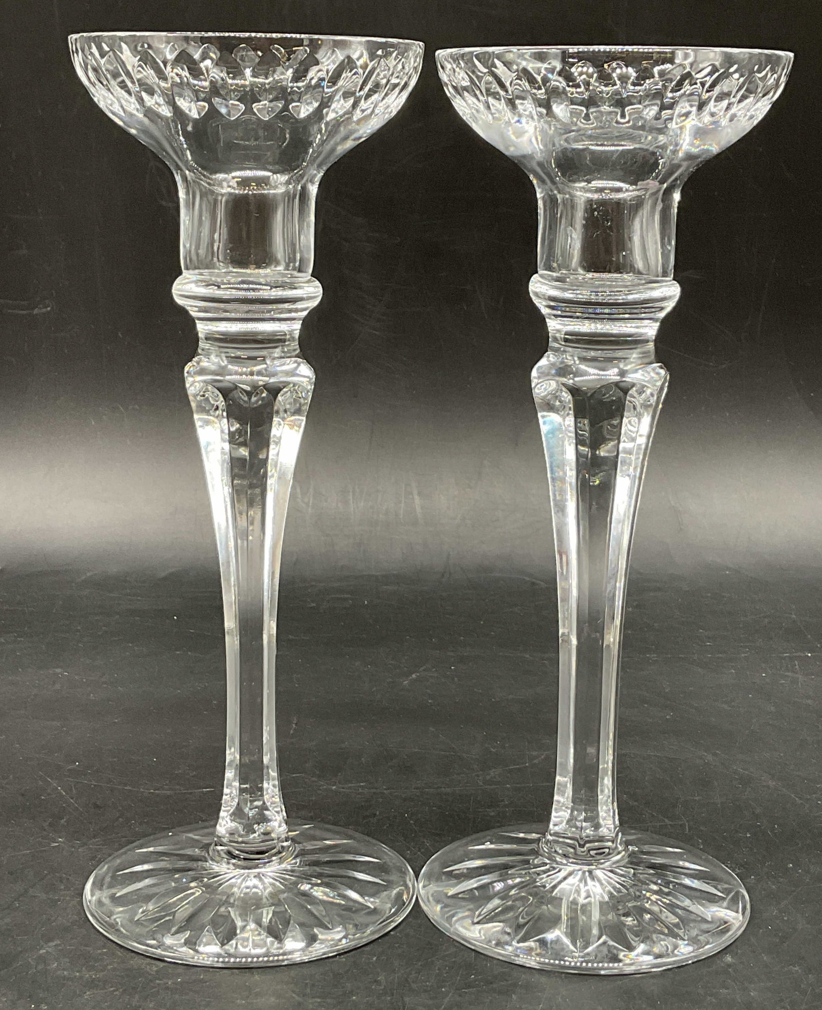 Pair Atlantis Georgian Cut Crystal Candlesticks: Pair of Atlantis Georgian cut crystal candlesticks. Round starburst base. Tall faceted stem. Narrow neck with wide candle cups. Geometric pattern. Measures ht approx 8 inches diam approx 3 inches. Scr