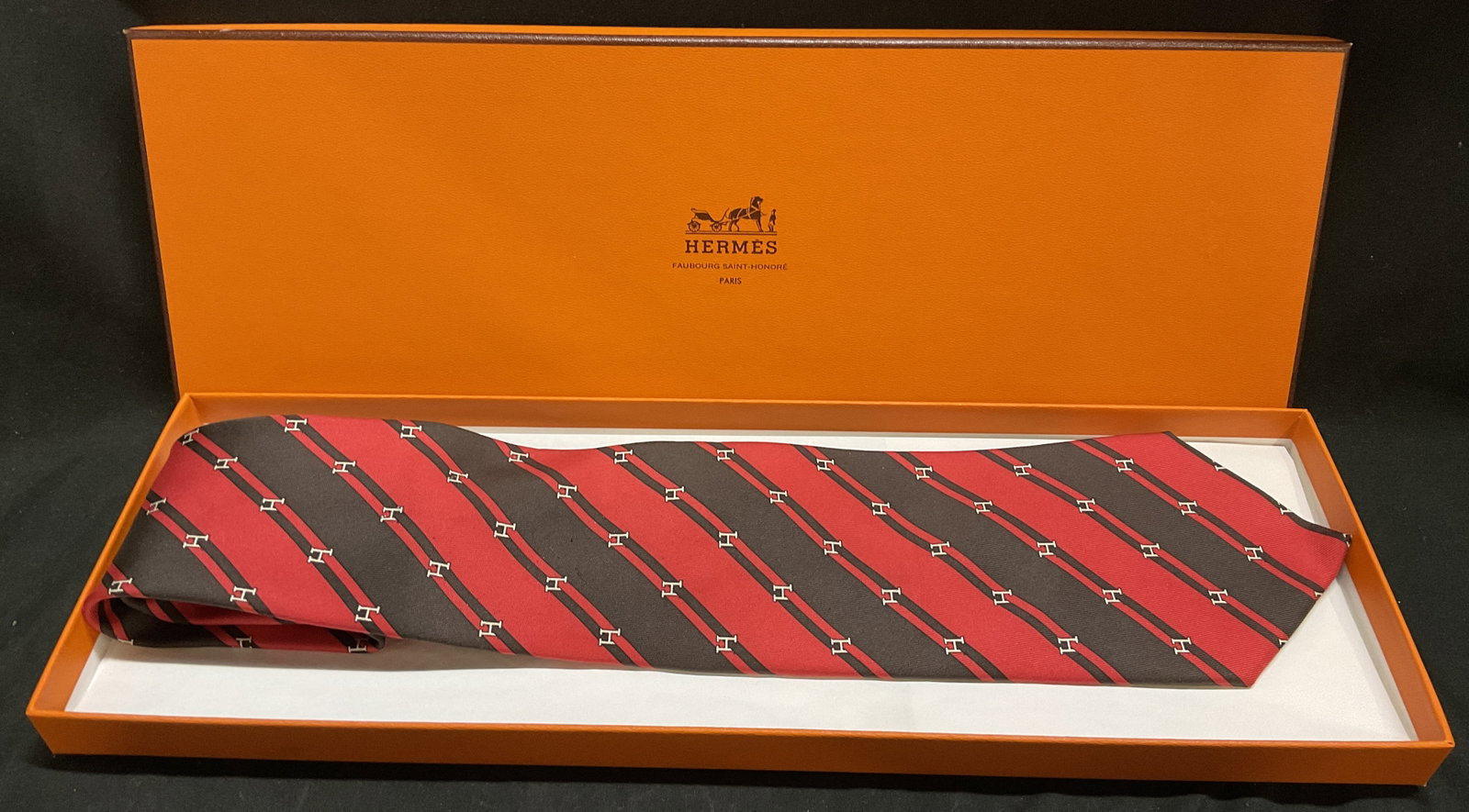 OB Hermes 100% Silk Twill H-Logo Necktie FRANCE: Hermes Paris 100% Silk Twill Necktie. Alternating Red and Brown Diagonal Stripes. Repeating White H Micro-Pattern. Original Box. France. Light Fraying. Measures app 58in L x 3.25in W. Hermes, Paris, S
