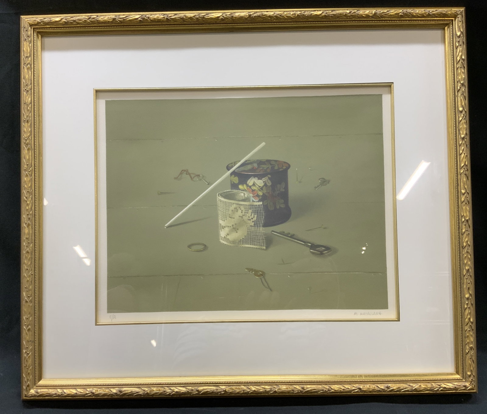 Vtg Sgnd Manuel Matallana Litho, Framed: Vintage c.1980s signed Manuel Matallana, Trompe lOeil Still Life with lace and key Color lithograph on paper. Depicts collection of domestic objects resting on muted green wood paneled surface includi