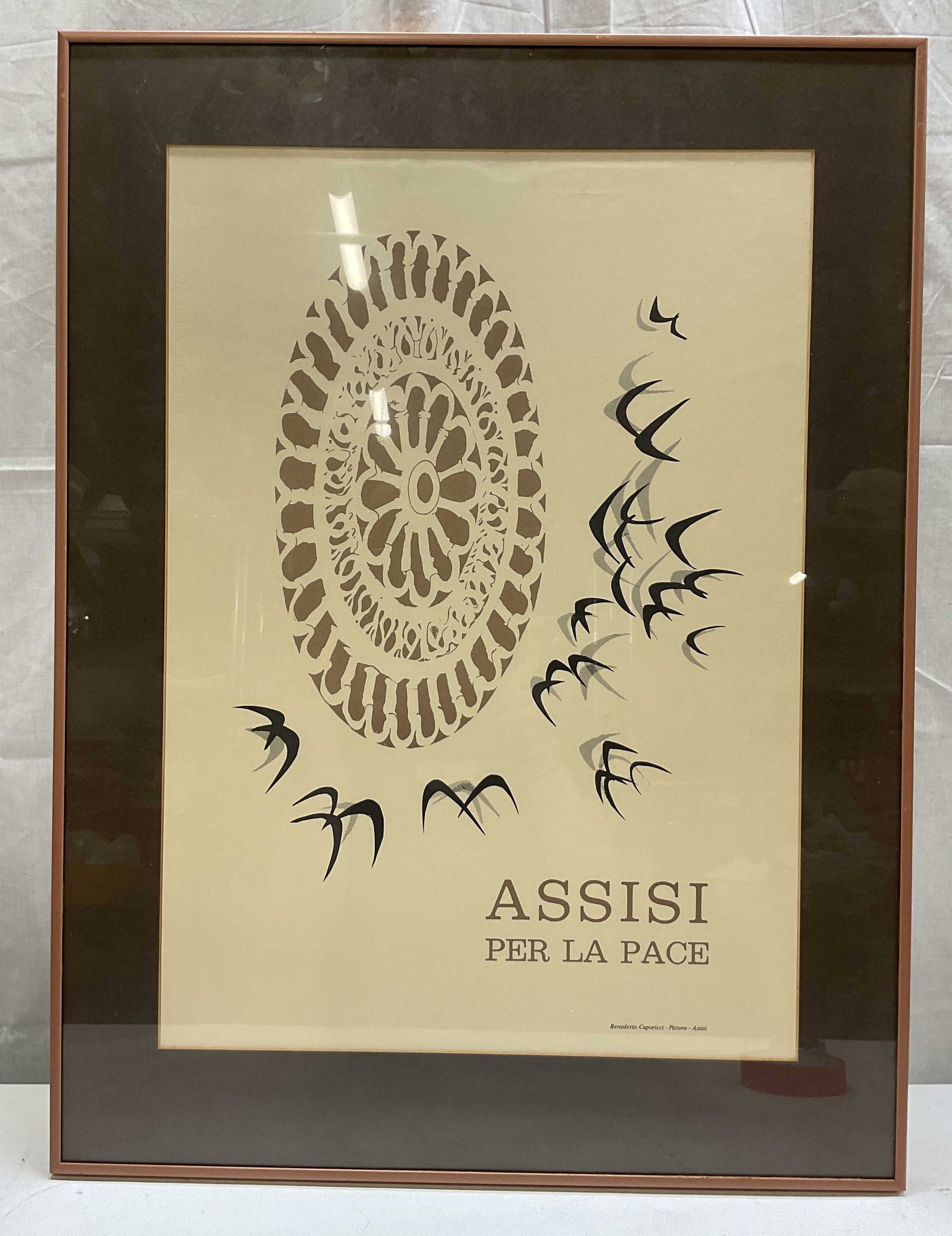 Assisi Per La Pace Framed Screen Print On Paper: Metal framed screen print on paper. Surface reads Assisi Per La Pace Benedetto Caporicci Pittore Assisi. An Italian promotional poster dedicated to peace in Assisi. Depicts a stylized cathedral rose w