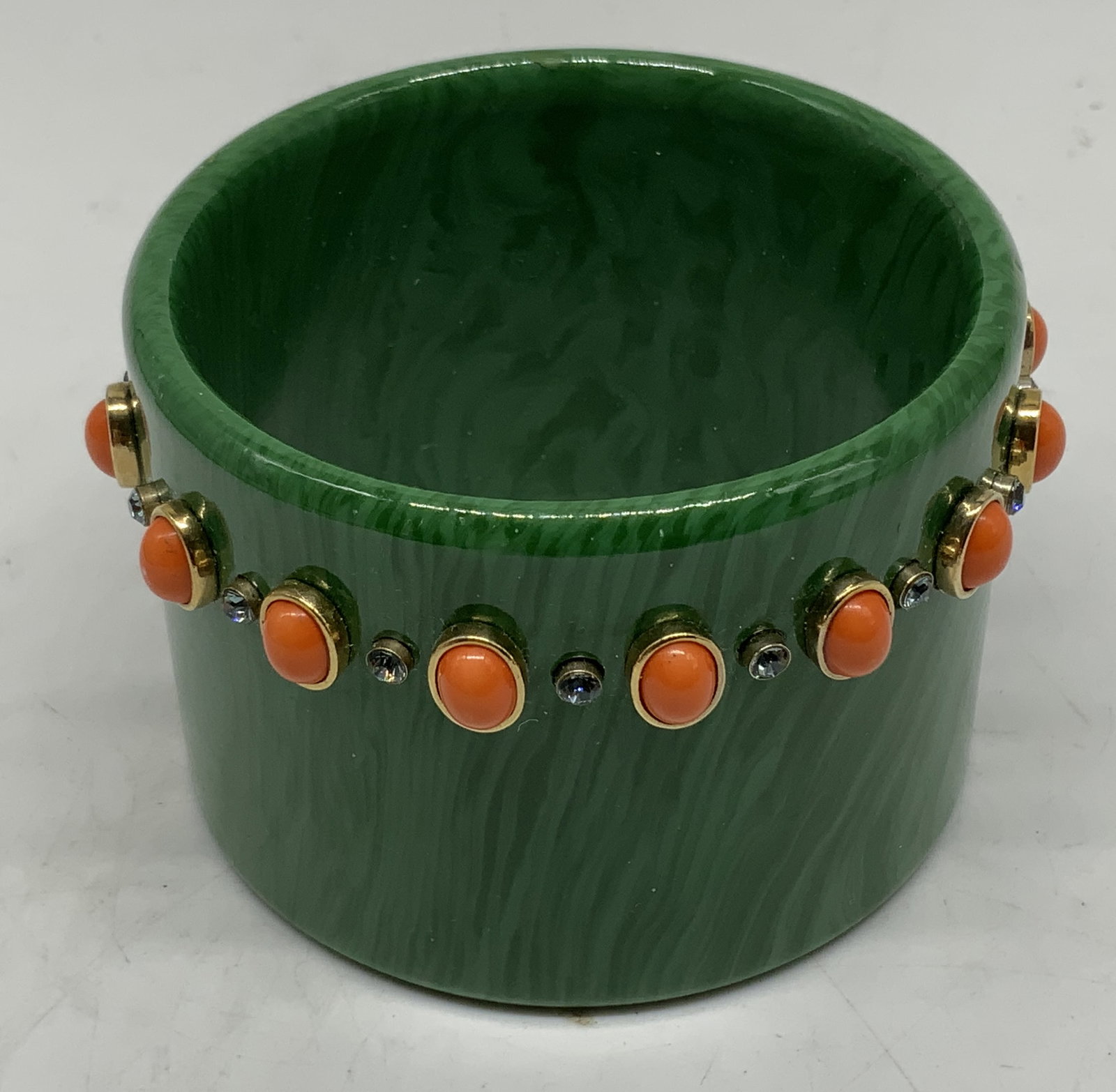 V. Kenneth Jay Lane Green Resin Cabochon Cuff: Vintage c.1980s Kenneth Jay Lane chunky statement cuff costume jewelry bracelet. Wide clamper-style bangle features marbled, striated emerald green resin body accented by a central row of smooth oval 