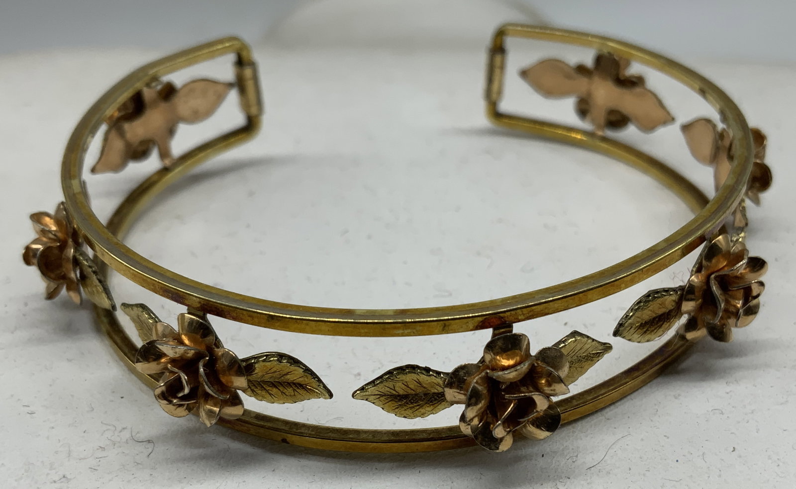 Vtg c.1970s Krementz Two-Tone Gold Rose Cuff: Vintage circa 1970s Krementz Two Tone 14K Gold Overlay- Yellow & Ross Gold Rose motif Cuff bracelet. Openwork filigree cuff bracelet features split-band frame adorned with three dimensional rose bloom