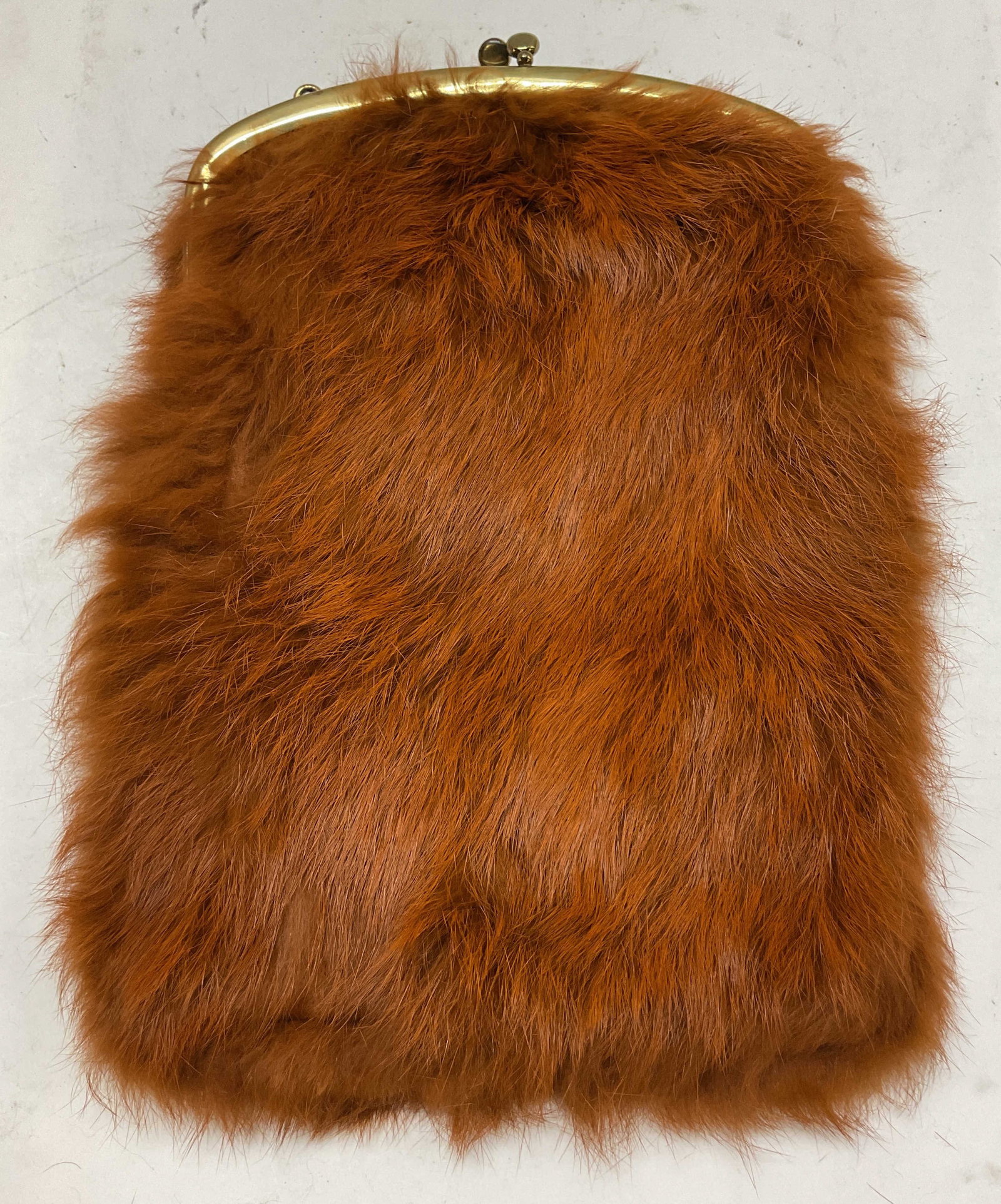 Vintage Dyed Fur Evening Purse: Vintage dyed fur evening purse. Orange red fur color. Gold toned attached chain strap and closure. Inside compartments. Measures approx 8 x 11 inches. Surface wear consistent with exposure. Evening