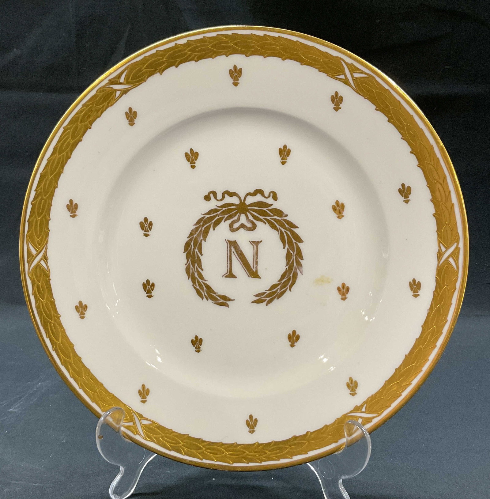 R. Briggs & Co Limoges Napoleon Plate France: R. Briggs & Co Boston Limoges porcelain Napoleon plate. Marked on underside as photographed here, made in France. Round plate with gilt edge. Features a central letter N surrounded by a laurel wreath,