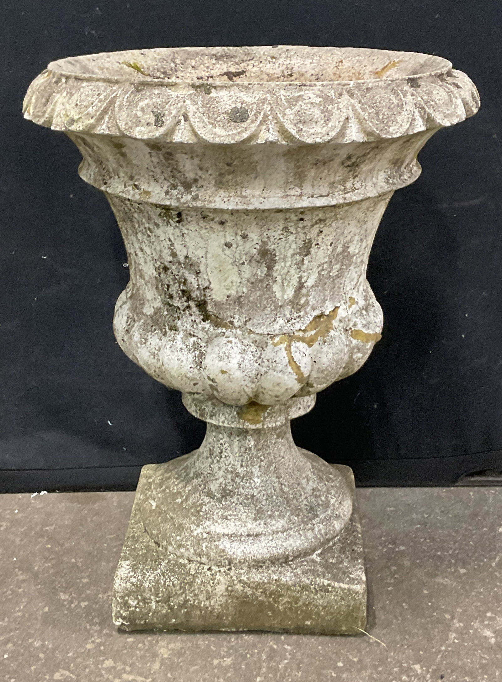 Large Classical Style Concrete Garden Urn Planter: Large classical style concrete garden urn planter. Broad flared opening detailed with a thick repeating scalloped pattern along the edge. Cupped bell shaped basin that tapers downward into a fluted ro