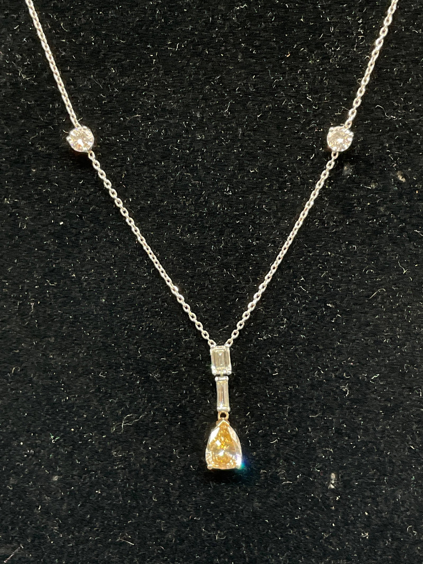 GEN CANARY DIAMOND White Gold Necklace: Stations-And-Drop Pendant Necklace. Suspended Genuine Pear-Cut Canary Diamond. Genuine Circular and Rectangular Diamonds in White Gold Chain. Chain Not Marked but Tested with PuriTEST. Gems Tested wit