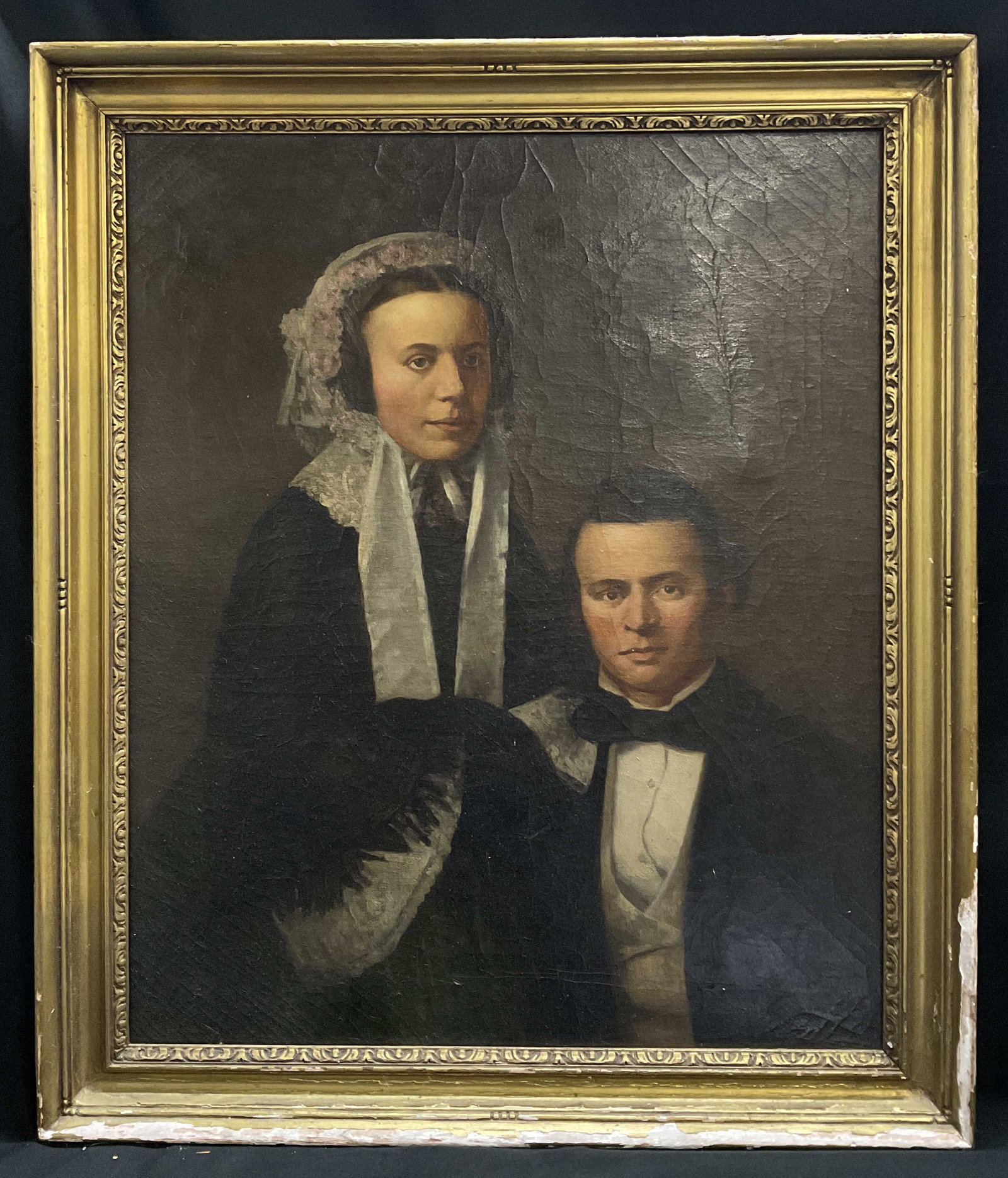 ANTQ American Folk Art Oil Painting Gilt Woo Frame: Antique 19th Century American Folk Art Oil Painting of Husband and Wife. Woman Wears Traditional Lace Bonnet and Dress and Man Wears Formal Black Suit. Giltwood Frame. Losses to Gold Leaf. Measures ap