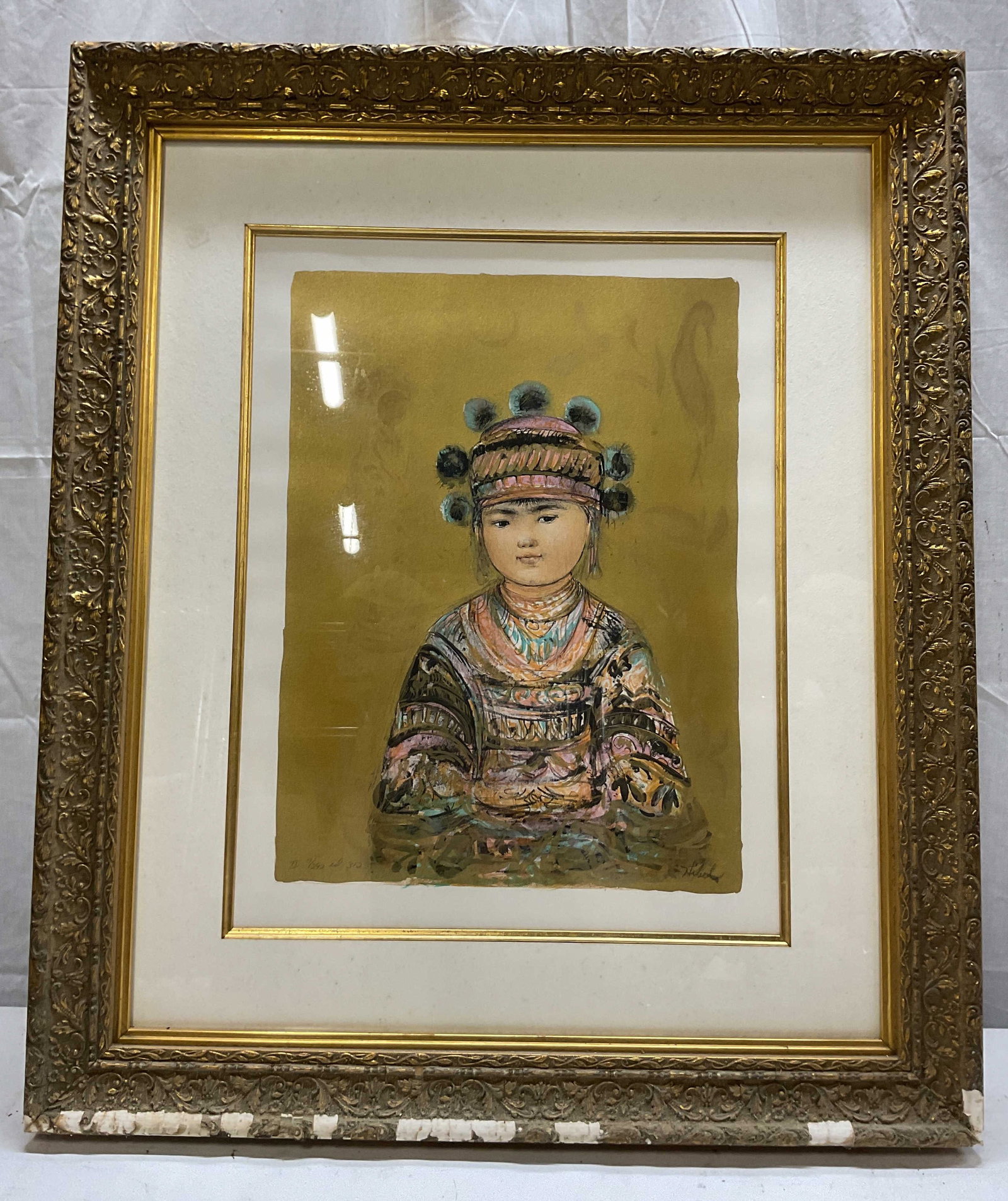 SGND Edna Hibel Hill Tribe Youth Framed Litho: Hill Tribe Youth by Edna Hibel. Framed limited edition lithograph on paper. Signed in lower right corner. Lower left corner reads 7/292 ed 3/2. The lithograph is housed within a dual layered white bor