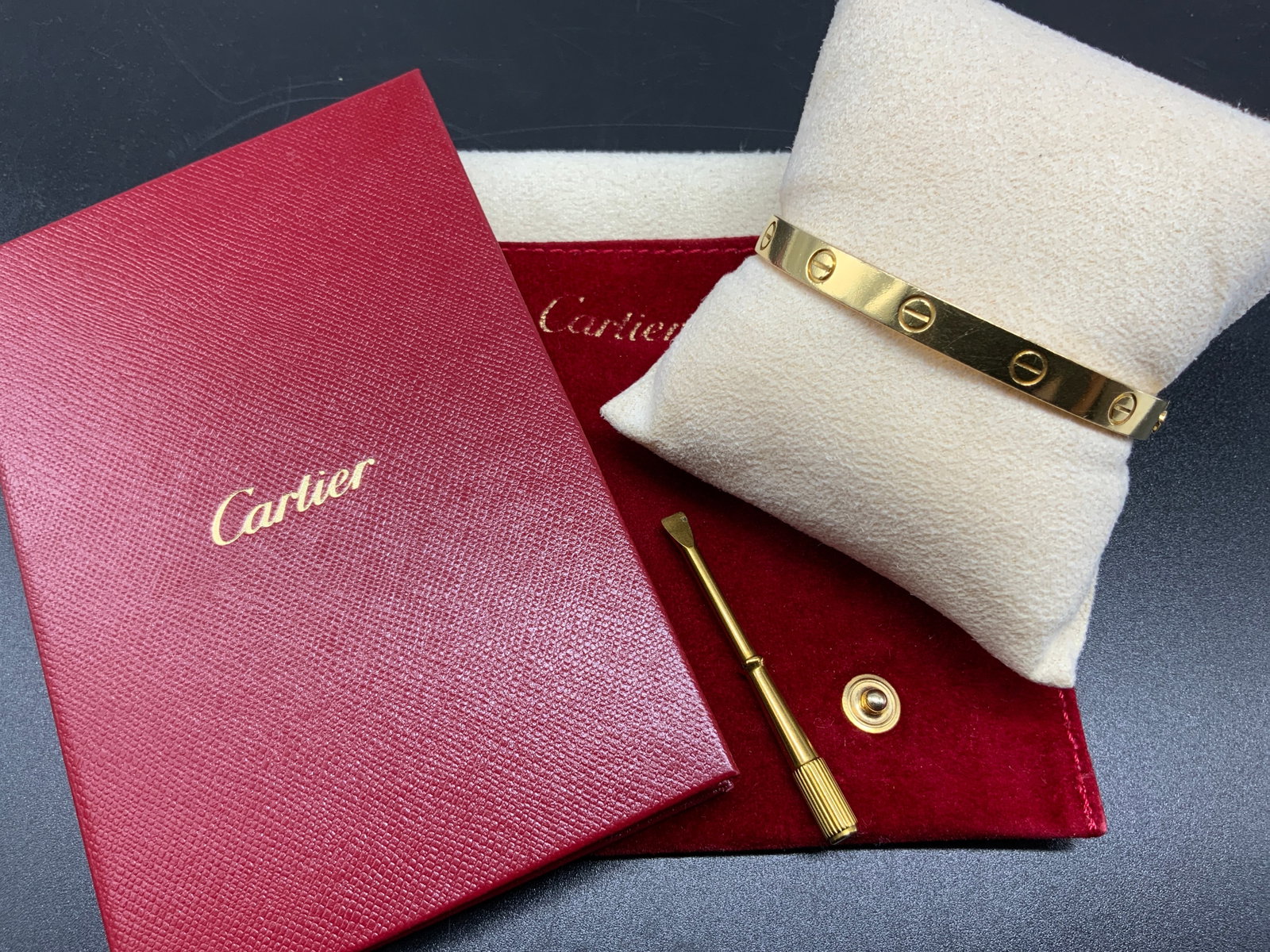 Cartier 18k Gold Love Bracelet w Tool + Cert.: Cartier 18k Gold Love Bracelet. Includes: 1x 18k Gold Love Bracelet, 1x Screwdriver closure tool, 1x Velvet Cartier travel pouch, 1x Certificate. Size 17 Bracelet alone weighs 30.9g (GRAMS) Condition 