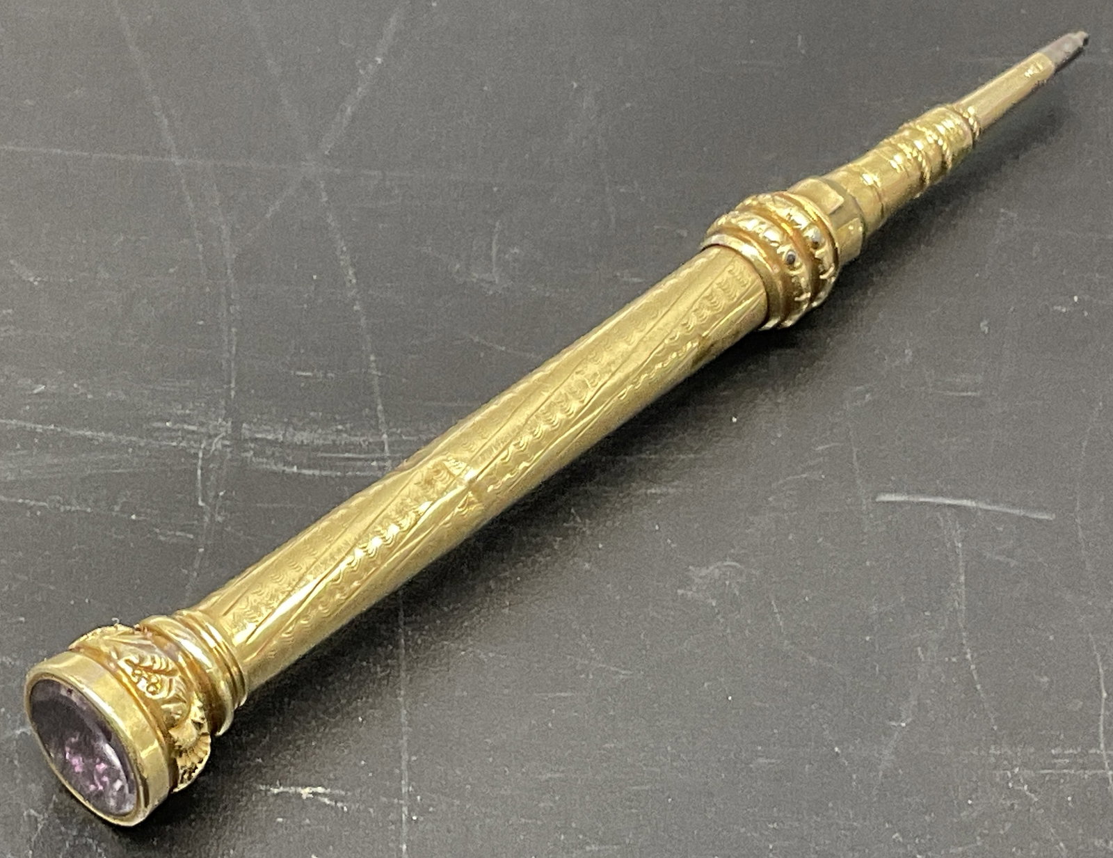 ANTQ 14K GOLD Gemstone Cap Mechanical Pencil: Antique Victorian 14K Gold Mechanical Pencil with Purple Semi-Precious Gemstone Cap. Not Marked But Tested With XRF Analyzer. Internal Mechanics Not Gold. Ornate Fluted Barrel with Decorative Sliding 