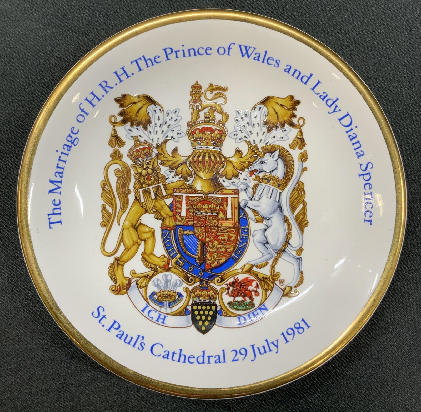 Vtg 1981Royal Marriage Souvenir Plate, England: Vintage 1981 Charles & Diana British Royal Wedding Souvenir Plate. Produced by Wood & Sons in England. Features Royal coat of arms on front with gold trim. Includes official stamp: Pride of Britain Wi