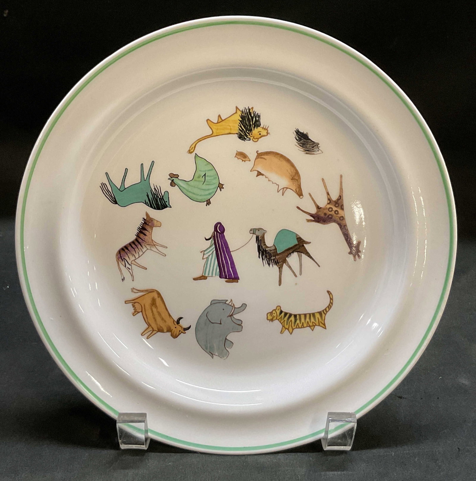 Arabia Animal Parade Porc Childs Plate Finland: Arabia Animal Parade porcelain childs plate. Marked on underside, reads Arabia Made In Finland. Green border. Features a playful and whimsical circular arrangement of colorful stylized zoo and circus 