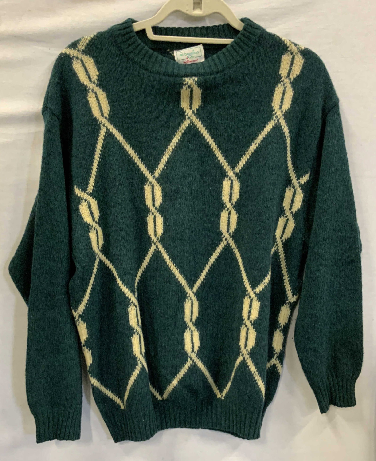 Vntg Benetton sweater. Italy 1980s: Vintage Benetton sweater with a geometric diamond pattern . Made in Italy in the 1980s. Made if 100% wool. Dark teal and cream colored. Label reads made in Italy, Benetton, Shetland wool. No size list