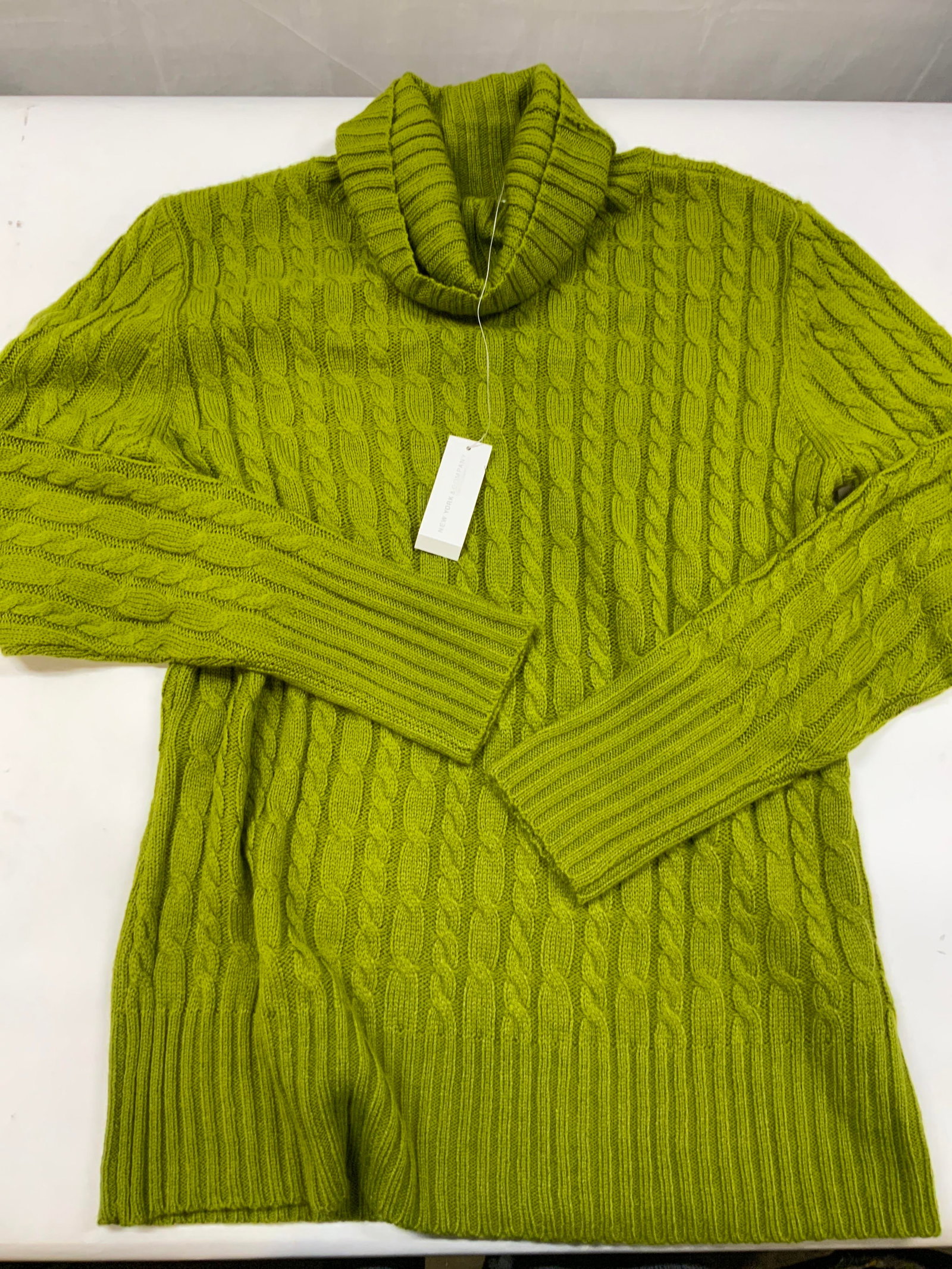 New York and Company cable knit sweater NWT: New York and Company cable knit sweater. New With Tags. Made of 100% acrylic in size XL. Full cable knit construction accented with vertical ribbing on the cuffs, hem line and neck. The cowl neck desi