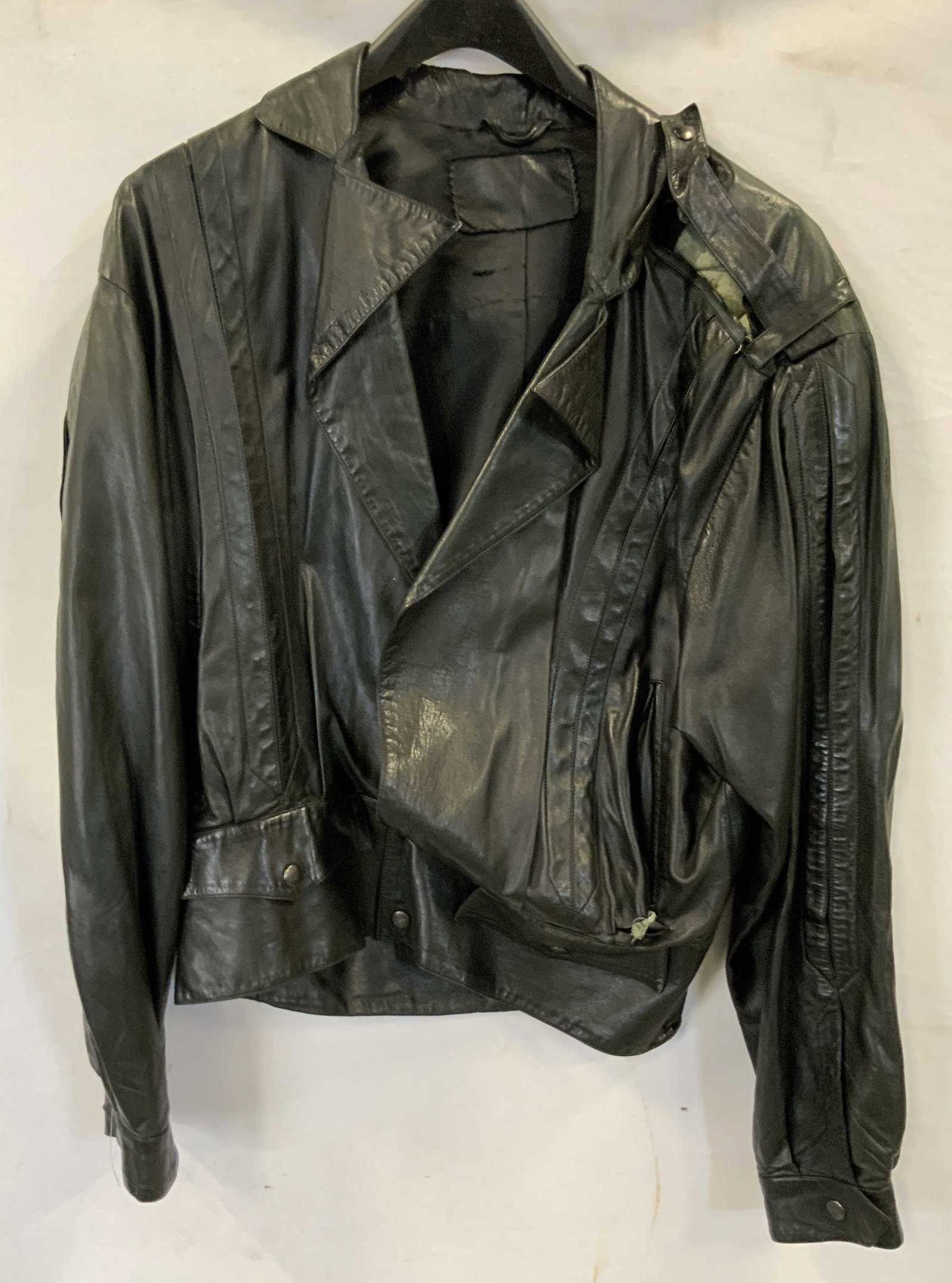 Lamb leather pleated jacket. France: 100% Lamb leather pleated jacket. Made in France. Jacket has pleat details on the front, back, and sleeves. It also has snap details on the shoulders, waistband, and cuffs. It has 2 front pockets and