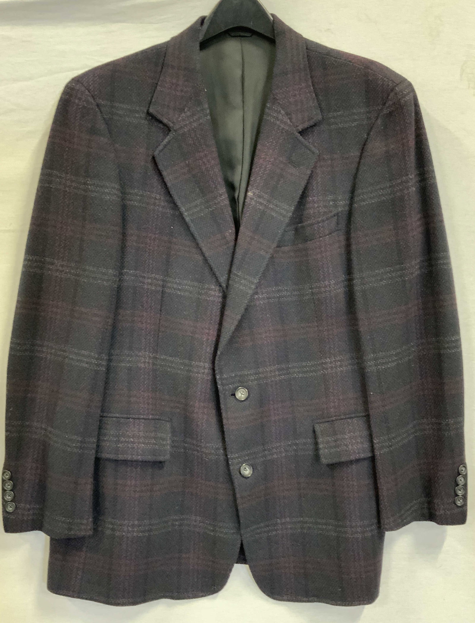 93The University Shop New Haven plaid blazer 1970s: Vintage The University Shop New Haven plaid blazer. Made in the 1970s. Size 44R. Jacket features a muted plaid with gray, burgundy, plum and crimson. Cuffs detailed with nonfunctional buttons. Traditi
