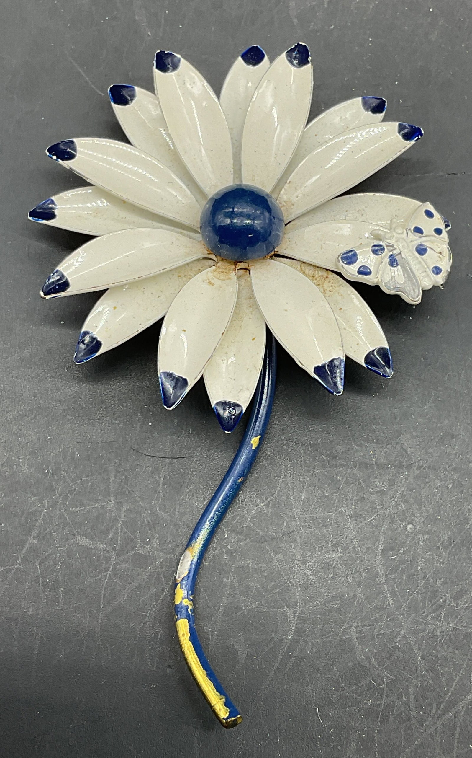 Vintage Enamel Flower Butterfly Brooch 3.25 In: Vintage blue and white enameled flower and butterfly brooch. Measures approx. 3.25 x 2 inches. Some loss to enamel and scratching. Jewelry, estate jewelry, costume jewelry, cocktail jewelry, fashion j
