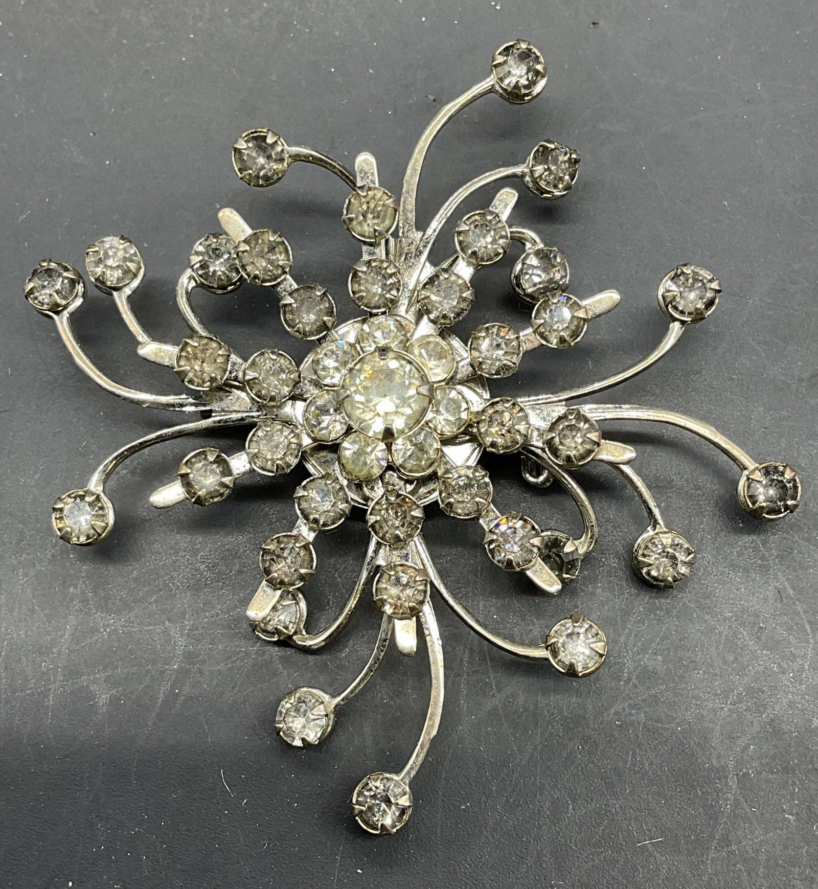 Silver Tone Crystal Flower Brooch: Silver tone flower brooch with colorless crystals. Measures approx. 2.25 x 2.5 inches. Some scratching. Jewelry, estate jewelry, costume jewelry, cocktail jewelry, fashion jewelry, accessories, fashio