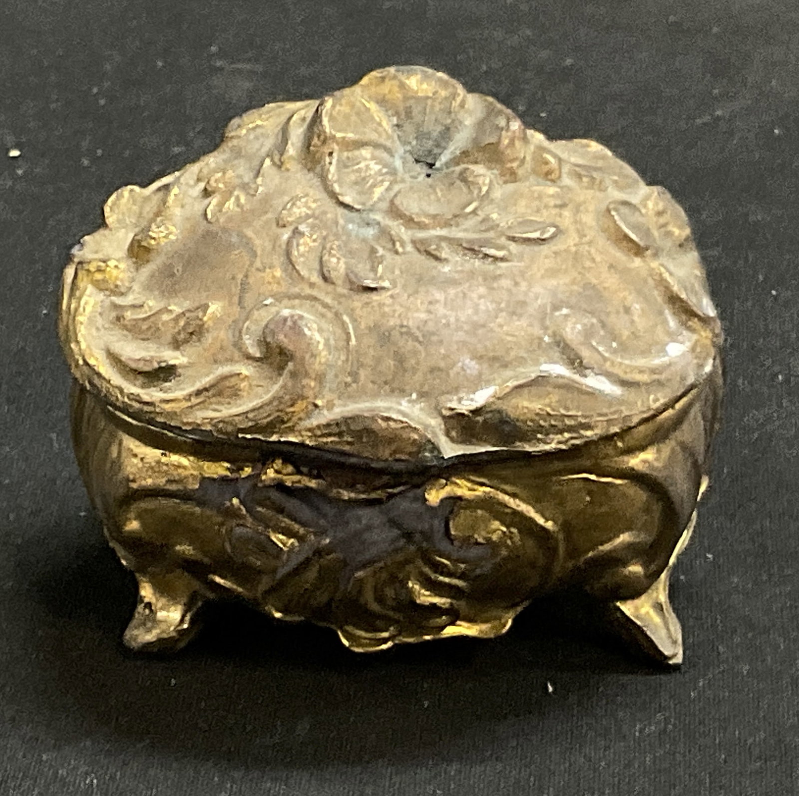 ANTIQUE Gilt Metal Trinket Box: Antique Rococo Revival Style Gilt Metal Footed Trinket Box. Spelter Material. Floral Designs. Finish Loss Present. Measures app 1.75in H x 2in Diam. Antique Trinket Box, Rococo Revival Style, Miniatur