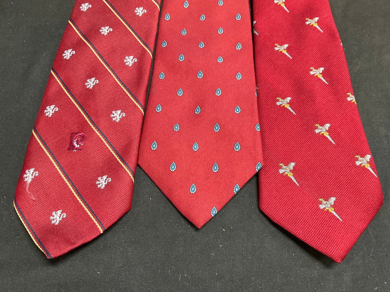 Lt3 VTG Designer+ Patterned Neck Ties ITALY+: 3 Vintage Red Patterned Neck Ties. Includes Circa 1970s Pierre Cardin Heraldic Lion Rampant Pattern Tie, a Flying Pheasant Silk Blend Tie, and a Circa 1970s-1980s John Henry Teardrop Patterned Silk Tw