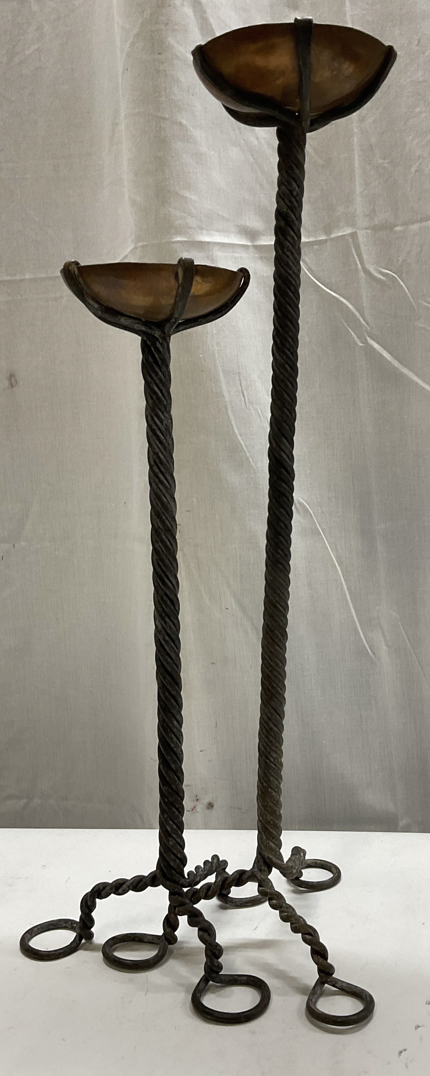 Pr VTG Iron&Copper Brutalist Pricket Candlesticks: Pair of Vintage Circa 1960s-1970s Brutalist Pricket Candlestick Holders. Twisted Wrought Iron Stems with Copper Candle Cups. Scratching, Oxidization, and Tarnishing Present. Tallest Measures app 19in