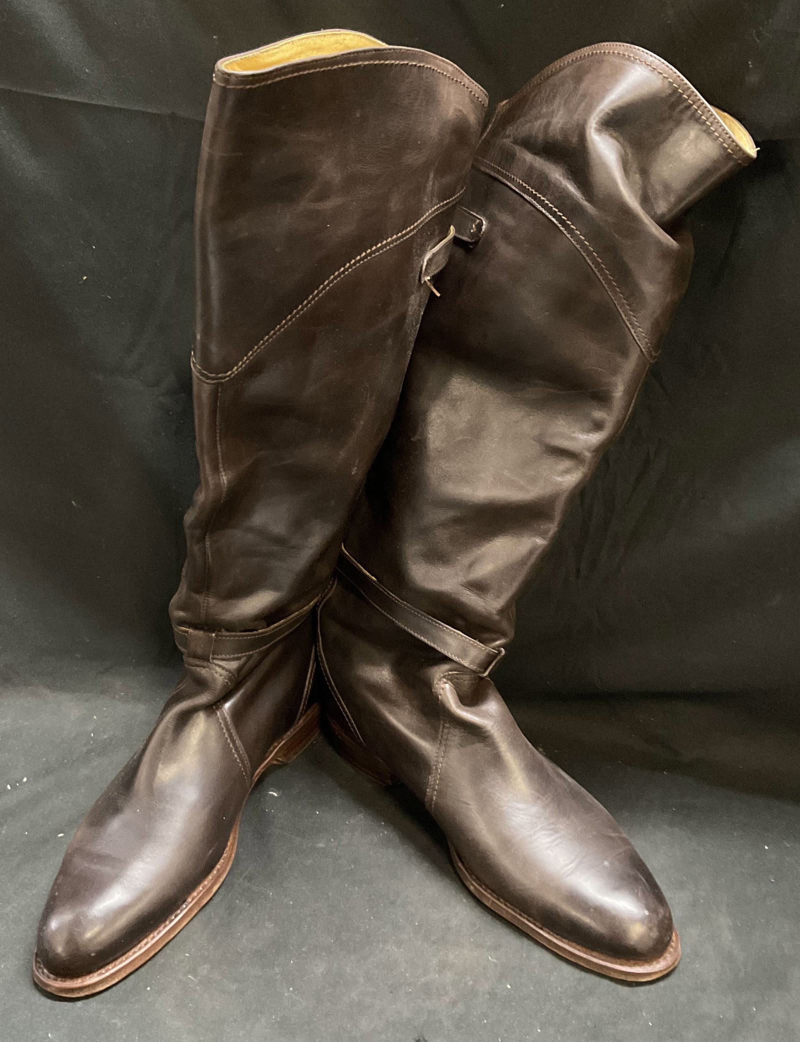 Frye Dorado Riding Boots SPAIN: Frye Dorado Riding Boots. Model 77561. Pull-On Design. Leather. Genuine Goodyear Welt Construction. Dual Buckled Fasteners. Stacked Heel. Spain. Size 10. Some Creasing and Fading. Comes with Storage B