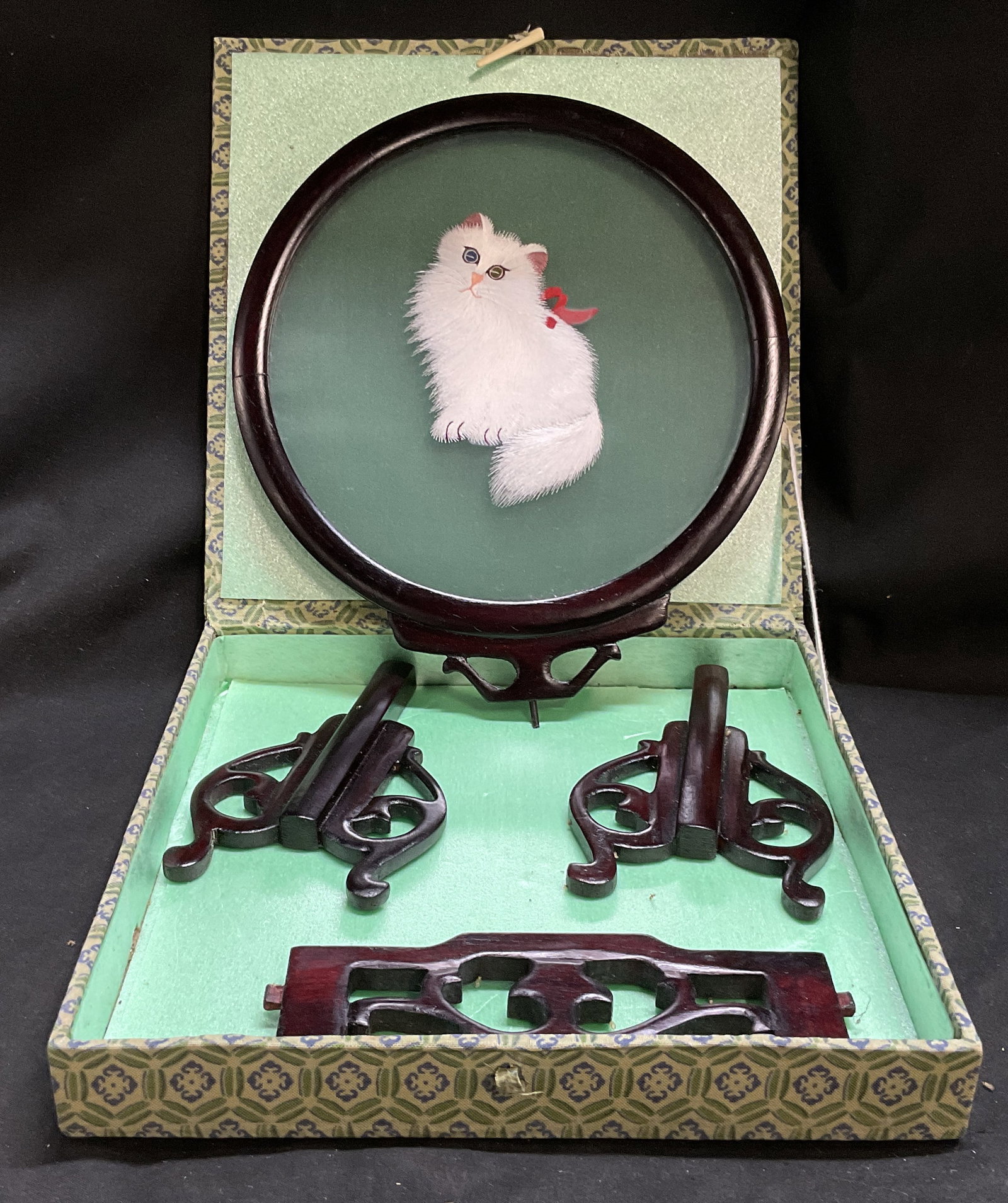 VTG CHNSE Silk Embroidered Cat Table Screen OB: Vintage Chinese Su Xiu Double-Sided Silk Embroidery Table Screen in Original Box. White Fluffy Cat Design. Comes with 3 Table Stand Pieces. Condition Consistent With Exposure. Measures app 8.5in Diam.