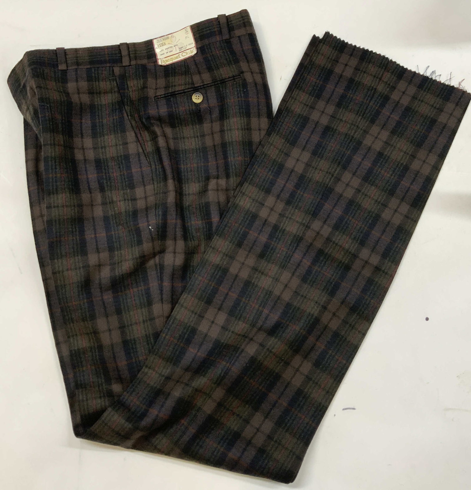 Vntg Racquet Club wool plaid trousers. USA NWT: Vintage Racquet Club plaid trousers. Made in the USA from 100% worsted wool. New With Tags. Size 32 waist. Features a muted earth tone tartan pattern. Zipper and clasp closure. Raw JEM, cut with linki