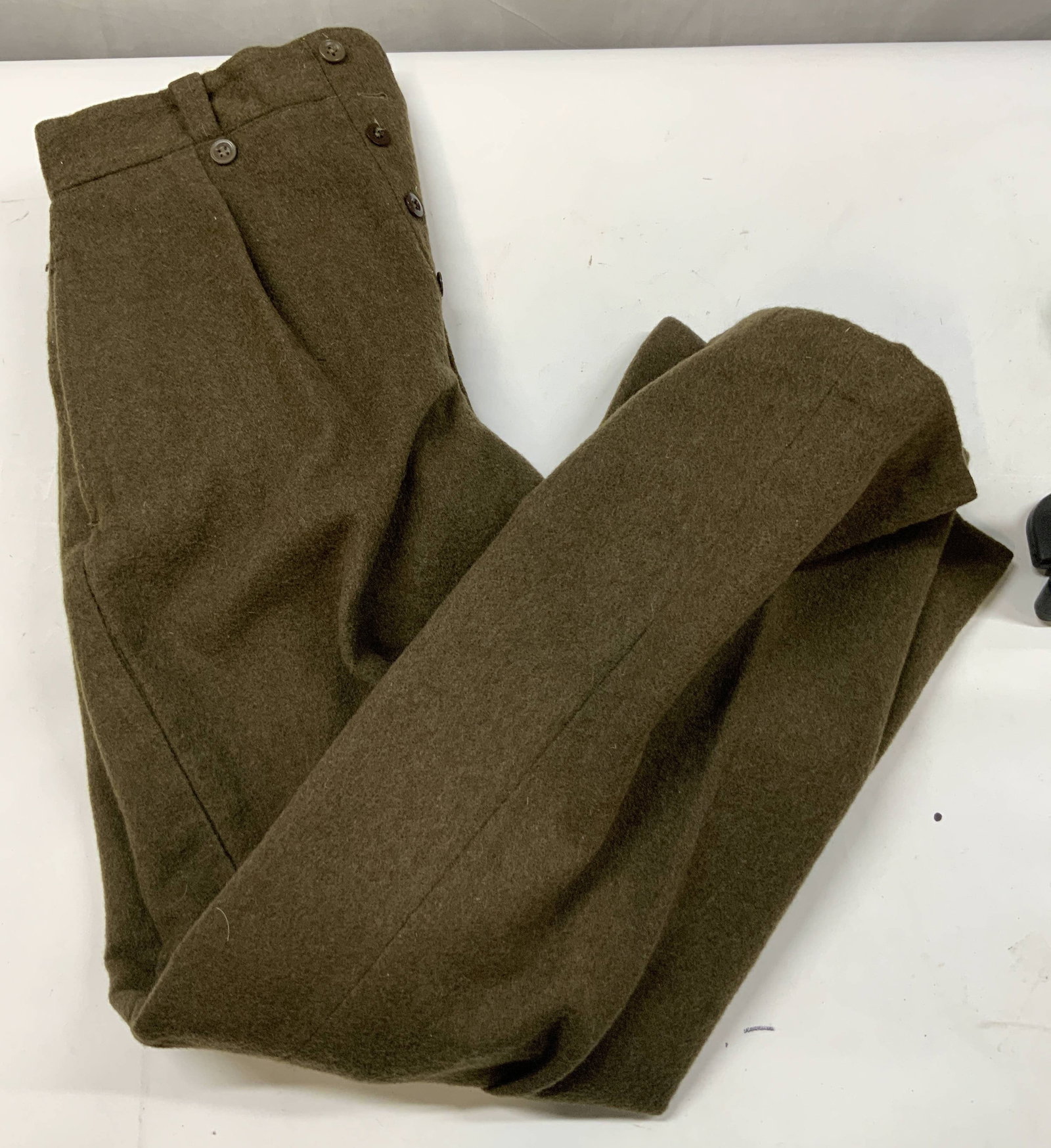 Vntg military issue wool field trousers. 1940s: Vintage military issue will field trousers. Used by the army during the 1940s. Size stamped inside waistband, size 30. Heavyweight olive wool flannel fabric. Features a button fly, cotton waistband li