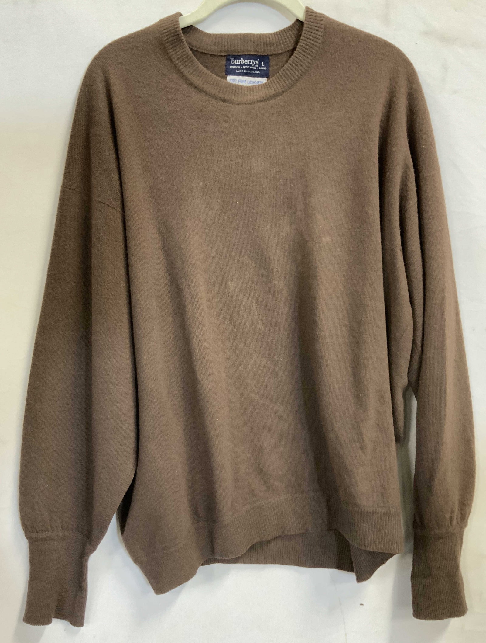 Vntg Burberrys cashmere sweater 1990s Scotland: Vinatge Burberrys brown cashmere sweater. Made in the1990s in Scotland out of 100% pure cashmere. Size Large. Cuffs , hemline , and neckline having ribbing details. Crewneck collar fit. Small hole on