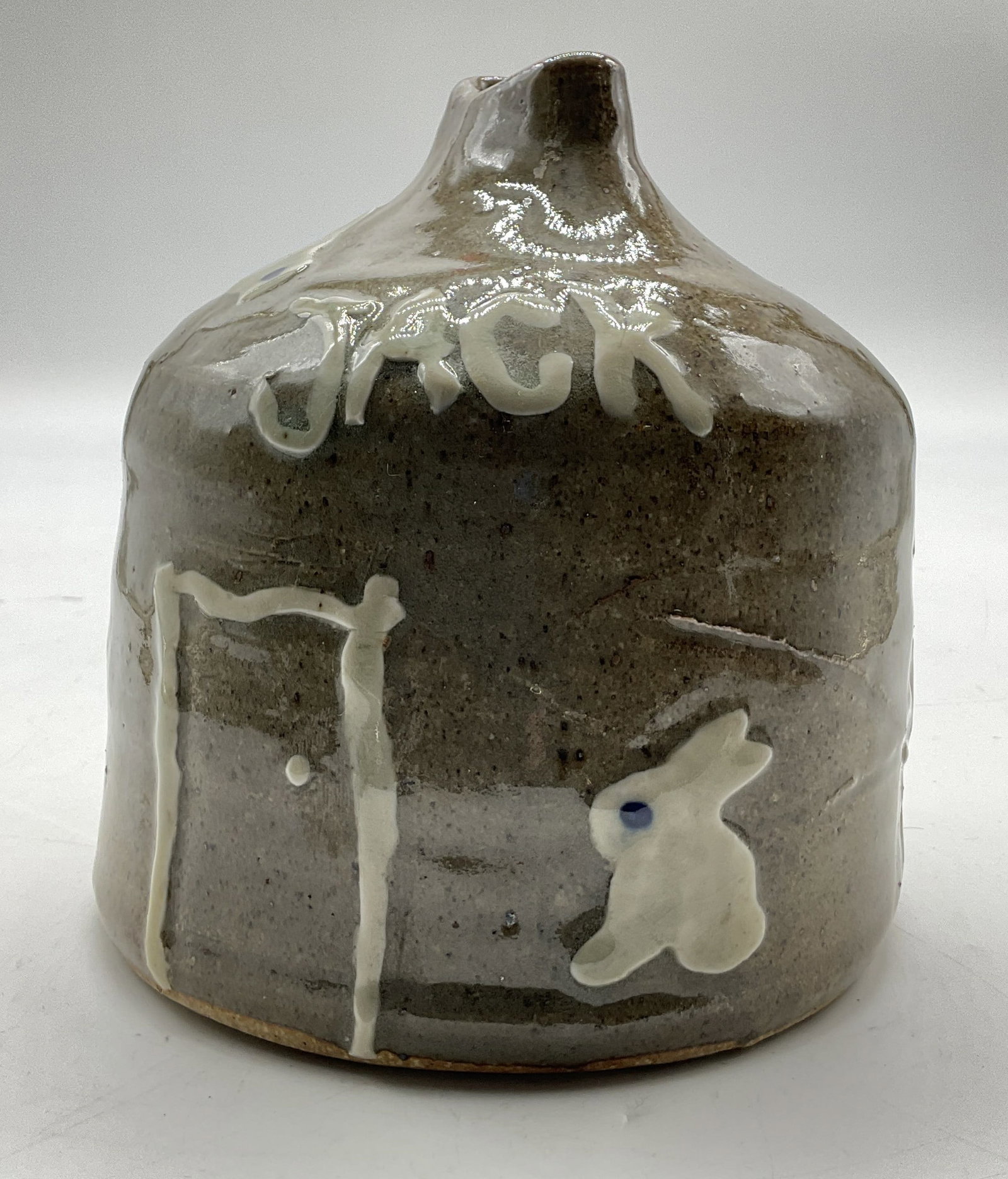 Vintage Stoneware Decorative Vessel: Vintage stoneware decorative vessel. Round body. Features the name Jack. Also features hand painted motifs of flowers, animals such as a rabbit, and a door. Glossy finish. Measures ht approx 6.5 inche