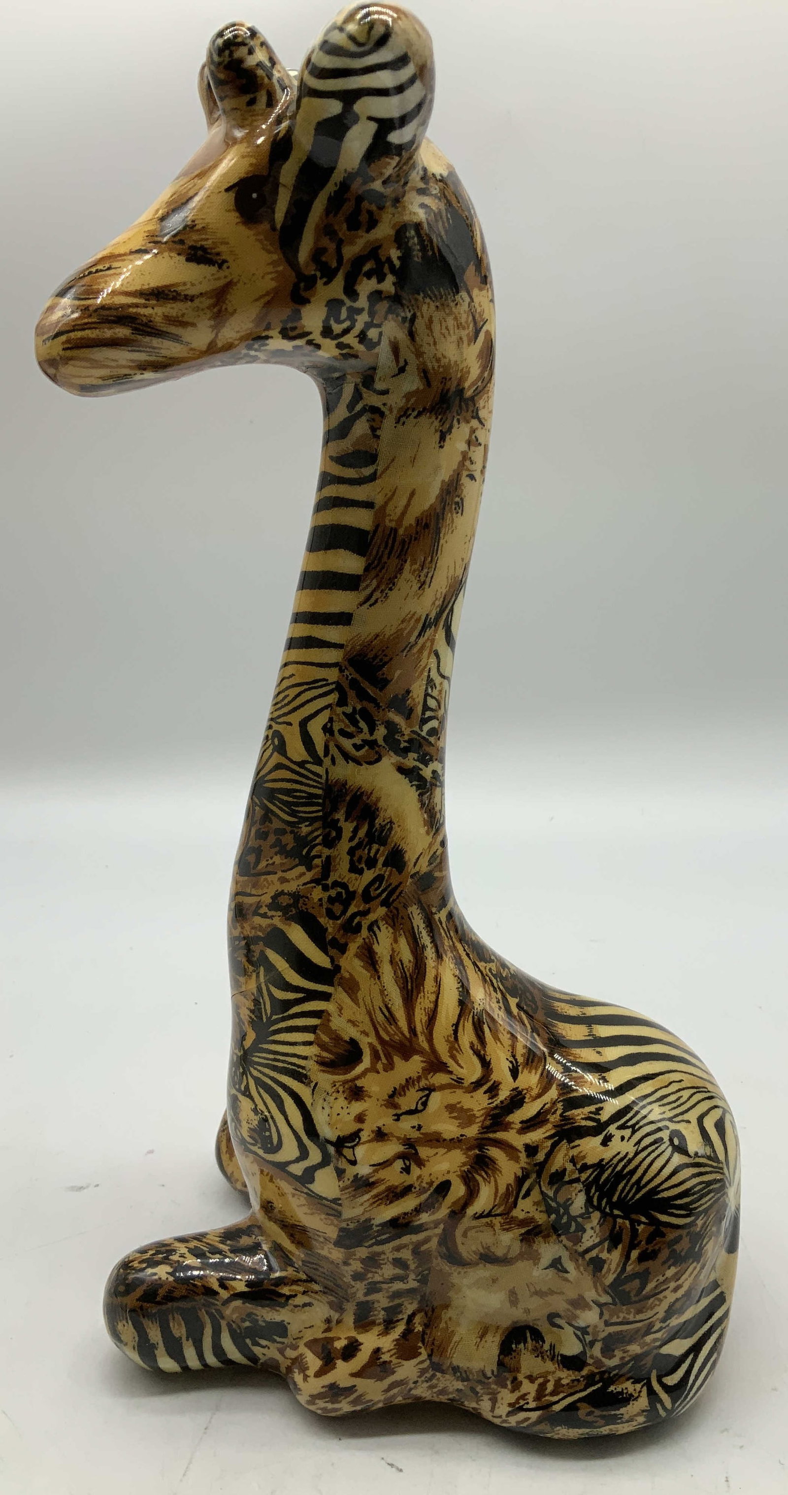 Vtg Seated Ceramic Giraffe Figurine: Vintage ceramic figurine depicting a seated giraffe with a decoupage design with various animal prints. Glossy finish. Surface wear consistent to age, use & exposure. Measurements: length 5.5in x