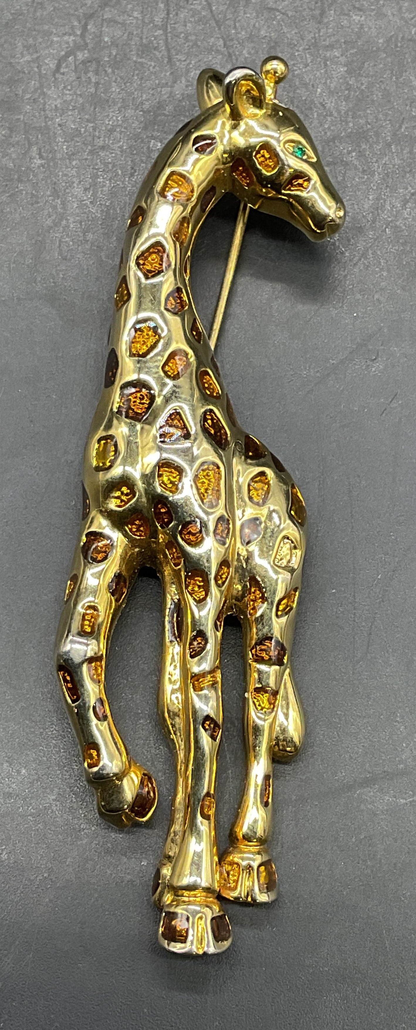 Gold Tone Enamel Giraffe Brooch 3.5 In L: Gold tone enameled giraffe brooch. Measures approx. 3.5 x 1 inches. Some scratching. Jewelry, estate jewelry, costume jewelry, cocktail jewelry, fashion jewelry, accessories, fashion accessories,
