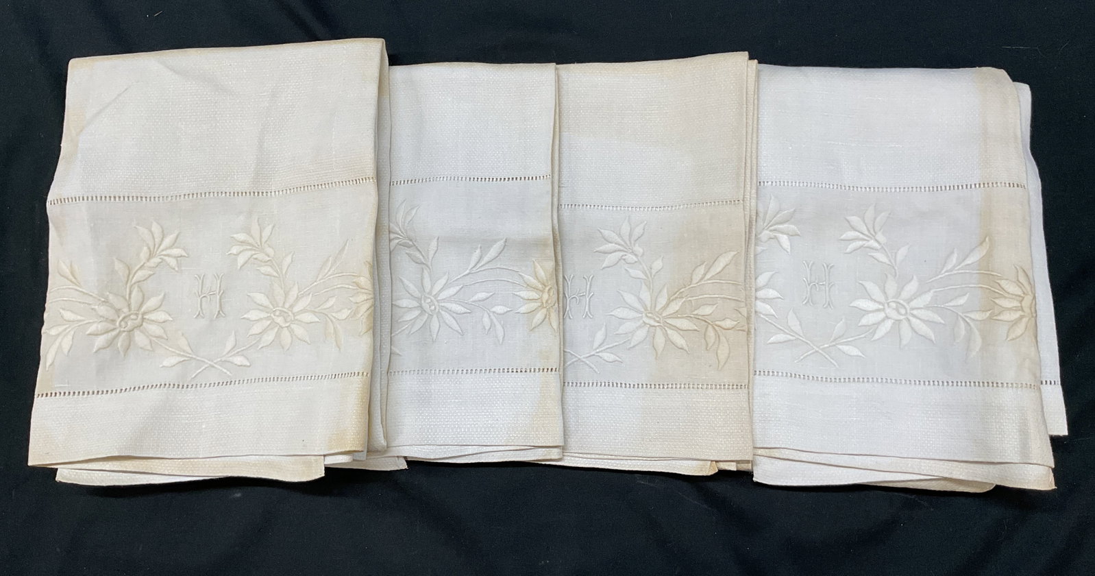 Lot 4 Vtg White Embd Monogram Linen Tea Towels: Lot of 4 vintage white embroidered monogram linen tea towels. Linen material. Embroidered floral motifs. Embroidered monogram with the letter H. Measures approx 23 x 40 inches. Blemishes observed. Tea