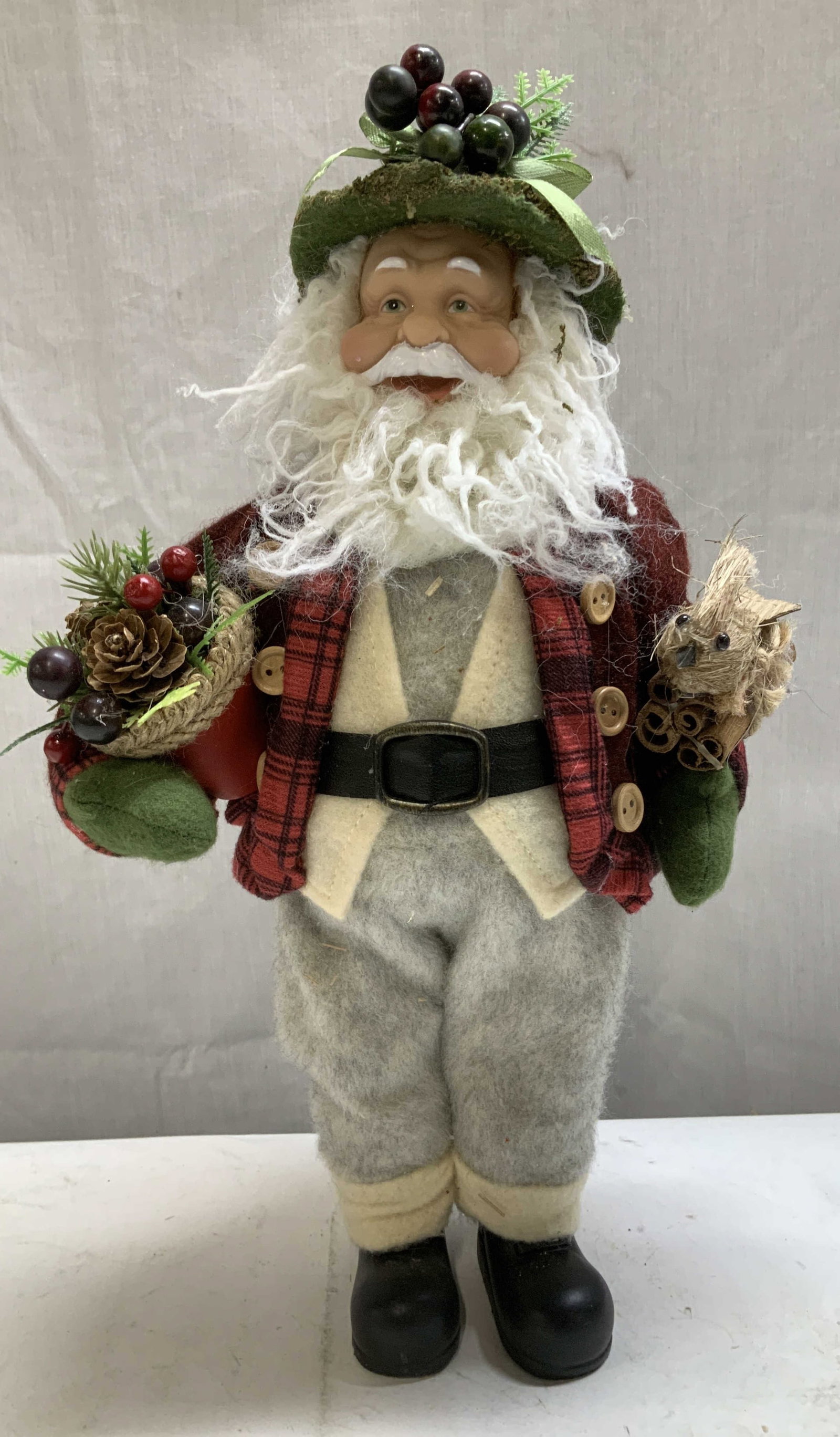 2010 Stocking Santa W Berries Figurine: Stocking Santa figurine is wearing a green hat adorned with berries & red plaid jacket. Surface wear consistent to age, use & exposure. Signed & marked on back. Reads, 2010-12-18. Santa figurine, stoc