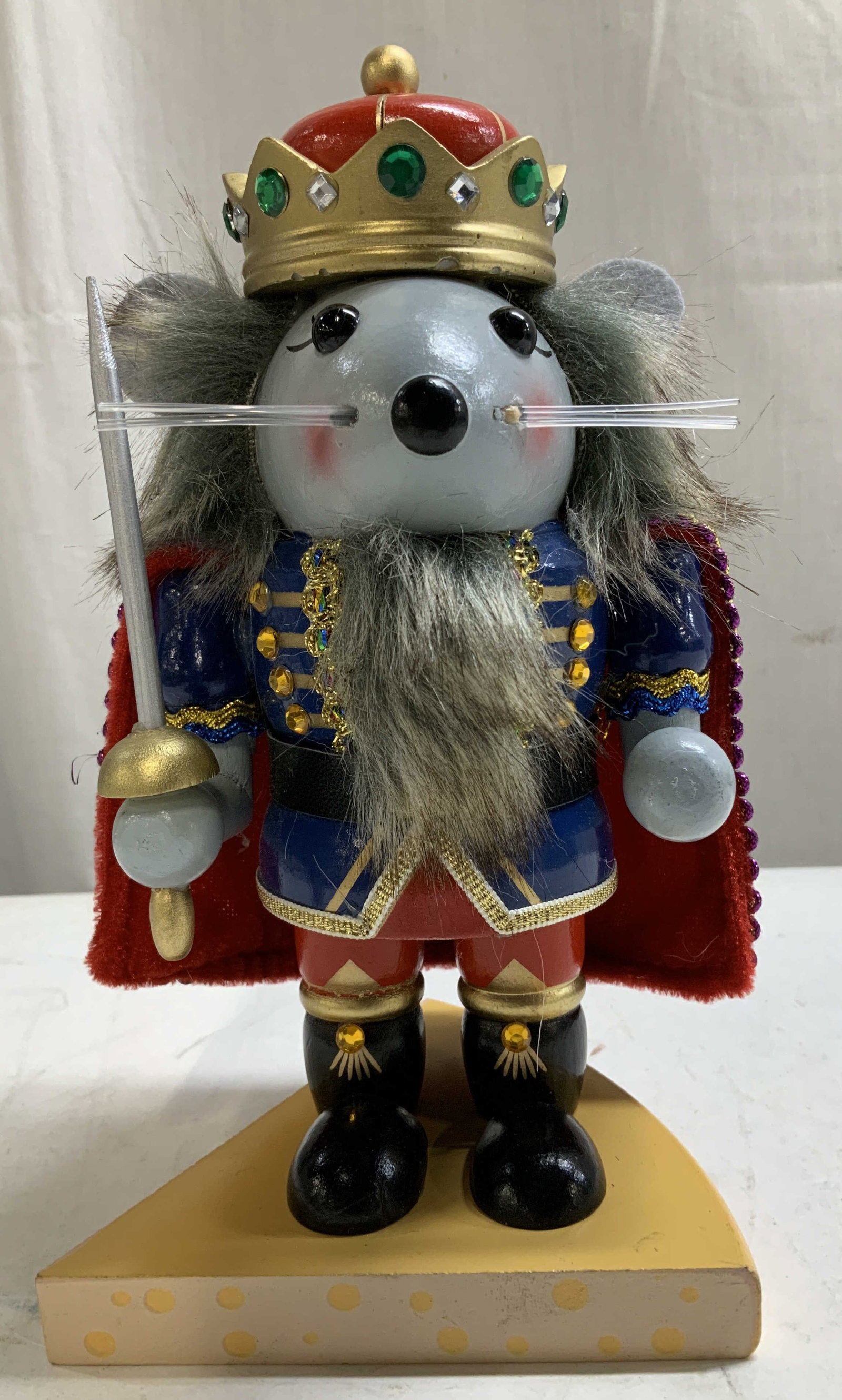 Hobby Lobby Mouse King Nutcracker: Hobby Lobby king nutcracker depicts a mouse dressed in a blue uniform with rhinestone accents. Stands on wooden cheese base. Surface wear consistent to age, use & exposure. Signed & marked on undersid
